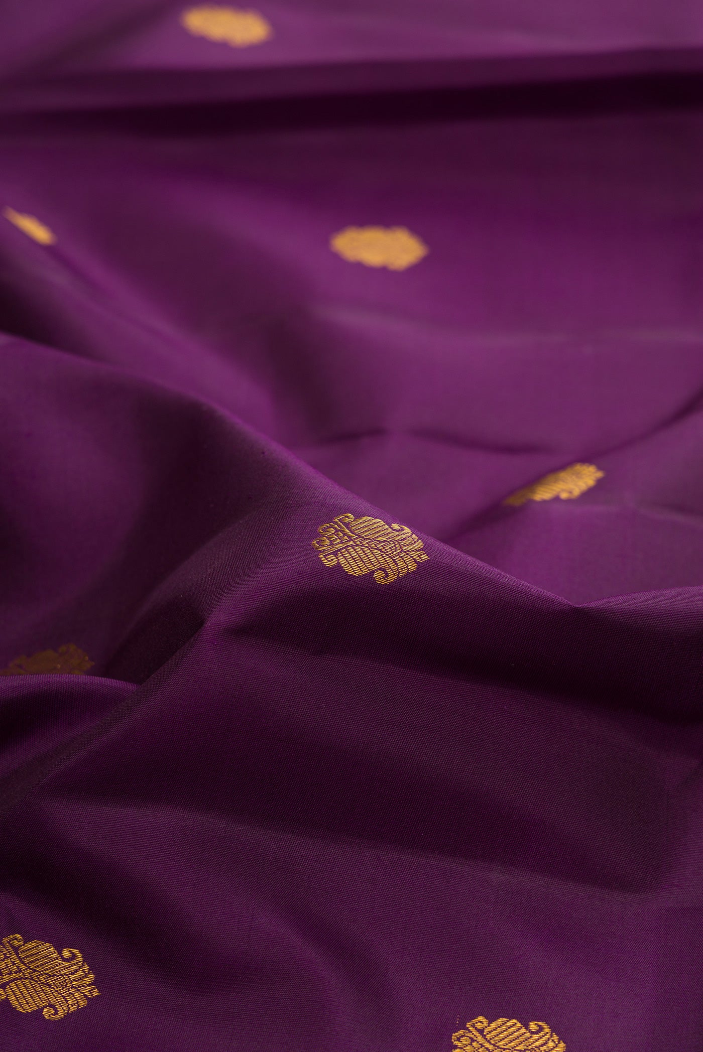 Close up of Pure Silk Purple Kanjivaram Saree with Zari Butta on the body and Zari Border.  displaying folds
