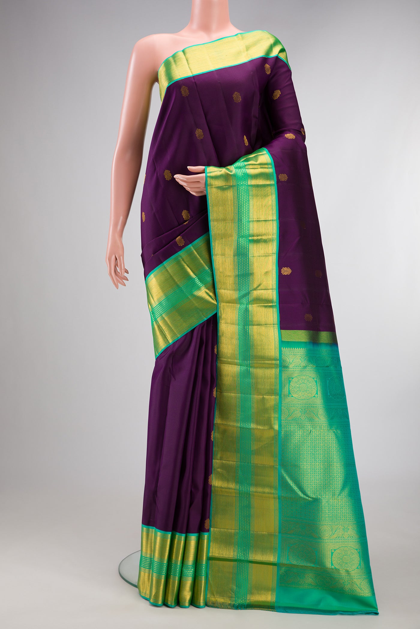 Pure Silk Purple Kanjivaram Saree with Zari Butta on the body and Zari Border.  displayed on a mannequin