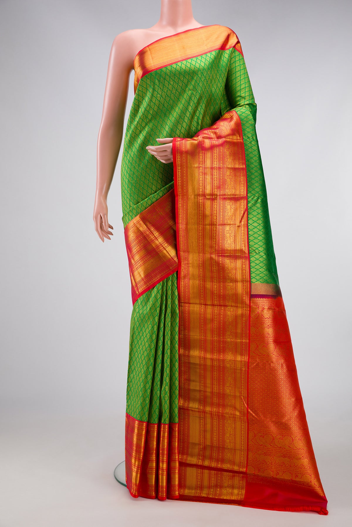 Green Kanjivaram Silk Saree with Zari Brocade on the body and Zari Border.  displayed on a mannequin