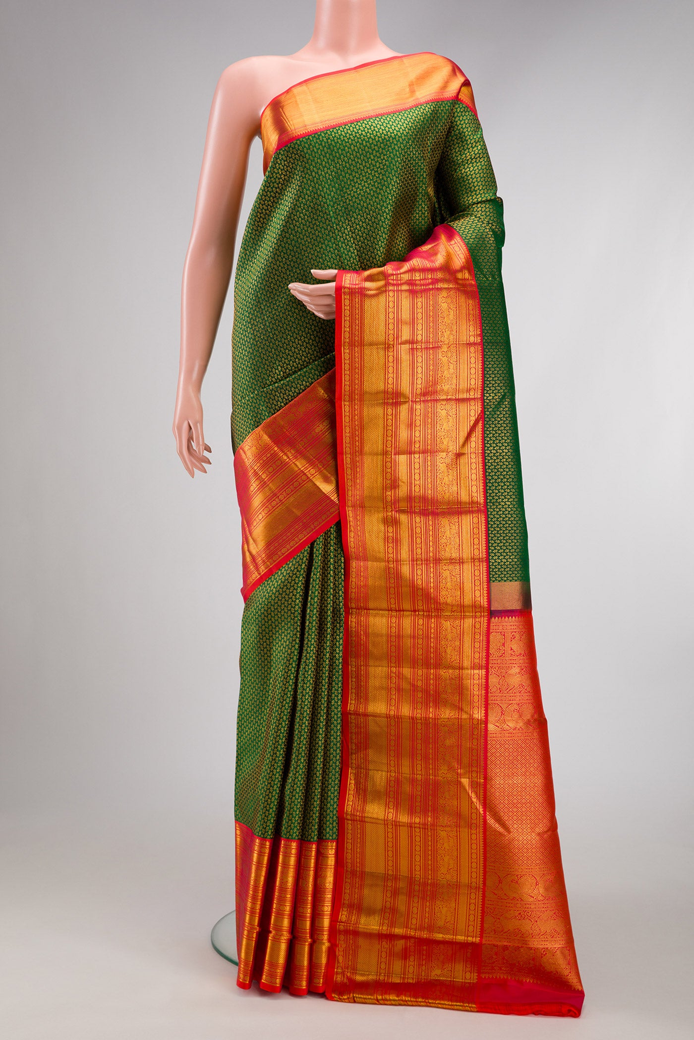 Green Kanjivaram Silk Saree with Zari Brocade on the body and Zari Border.  displayed on a mannequin