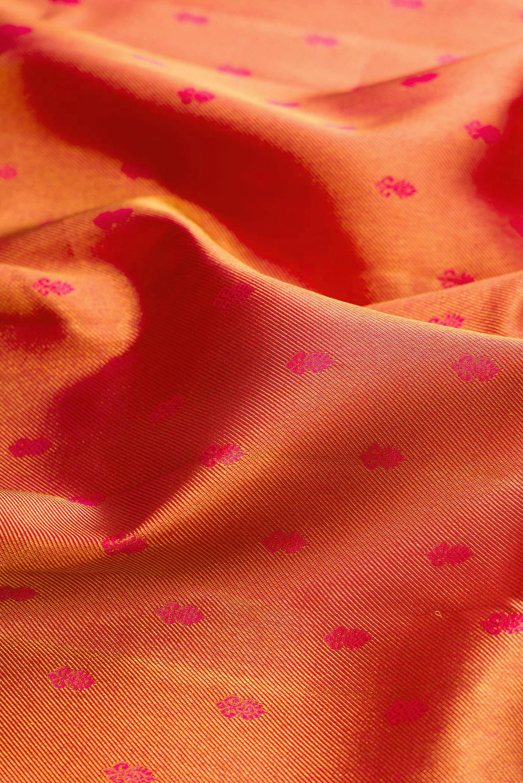 Close up of Red Dual Tone Kanjivaram Silk Saree with Zari Brocade on the body and Zari Border.  displaying folds