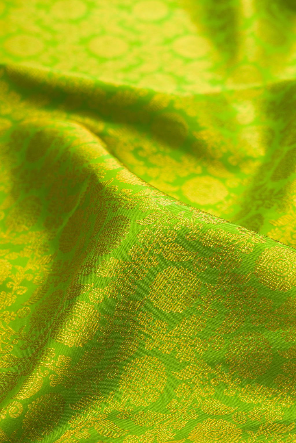 Close up of Pure Silk Parrot Green Kanjivaram Saree with Zari Brocade on the body and Zari Border.  displaying folds