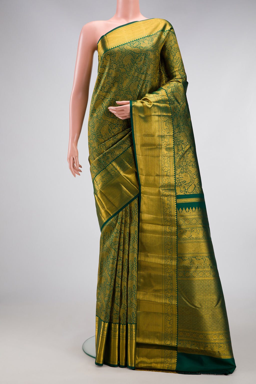 Green Kanjivaram Silk Saree with Zari Brocade on the body and Zari Border.  displayed on a mannequin