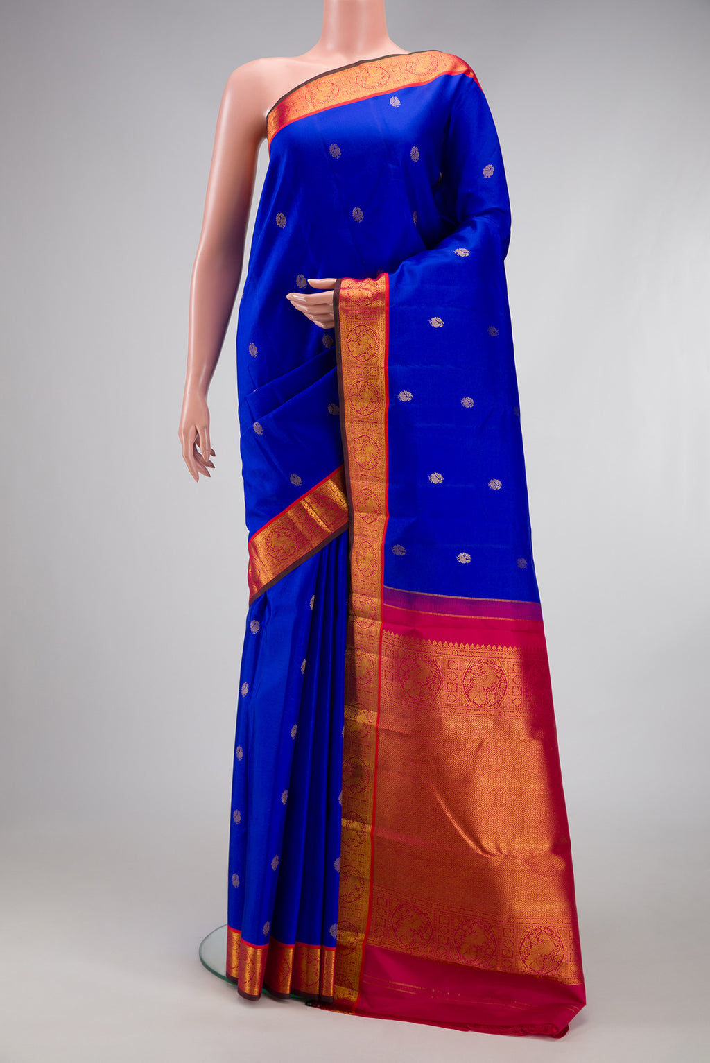 Royal Blue Kanchipuram Silk Saree with Zari Butta on the body and Zari Border.  displayed on a mannequin