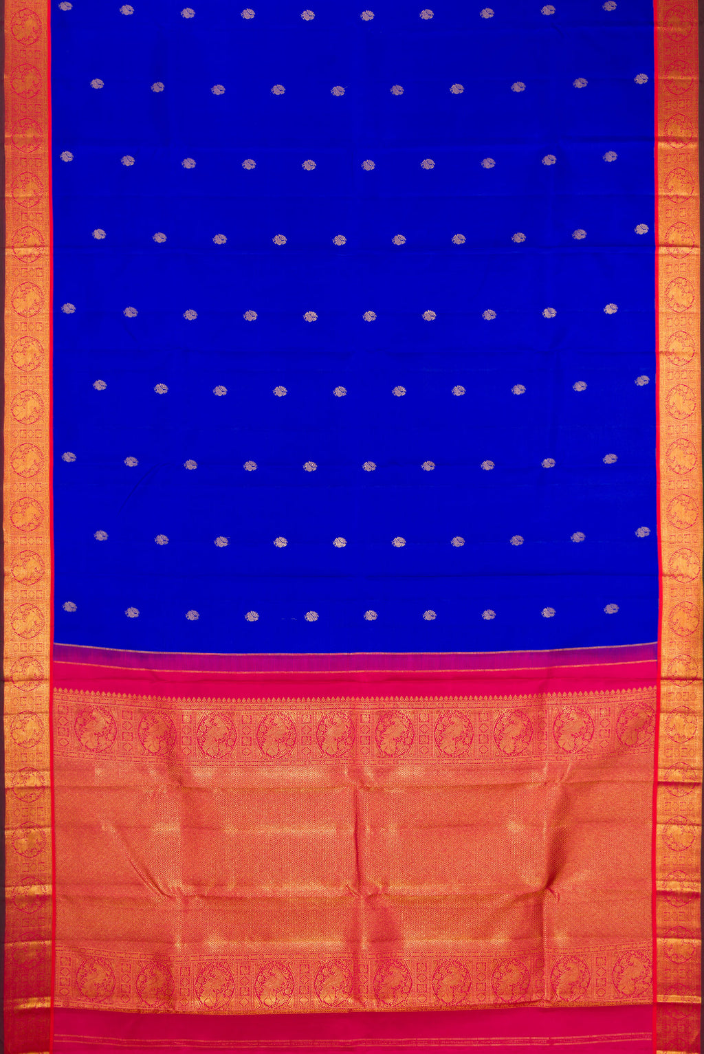 Flat view of Royal Blue Kanchipuram Silk Saree with Zari Butta on the body and Zari Border. 