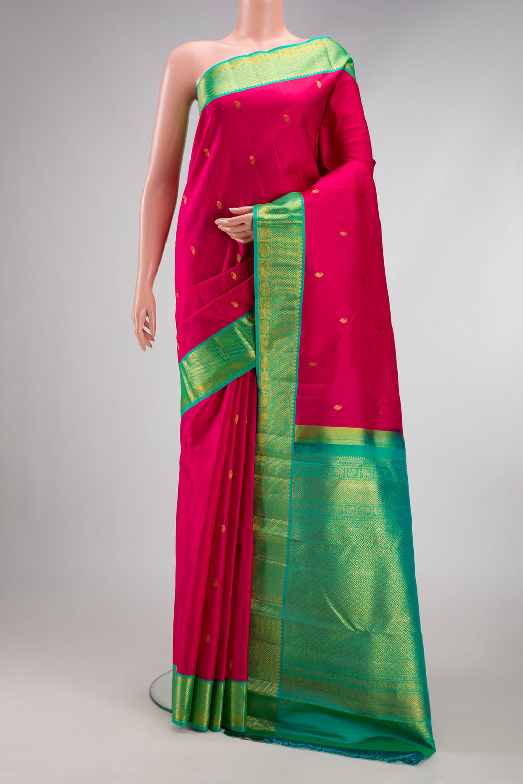 Dark Pink Kanchipuram Silk Saree with Zari Butta on the body and Zari Border.  displayed on a mannequin