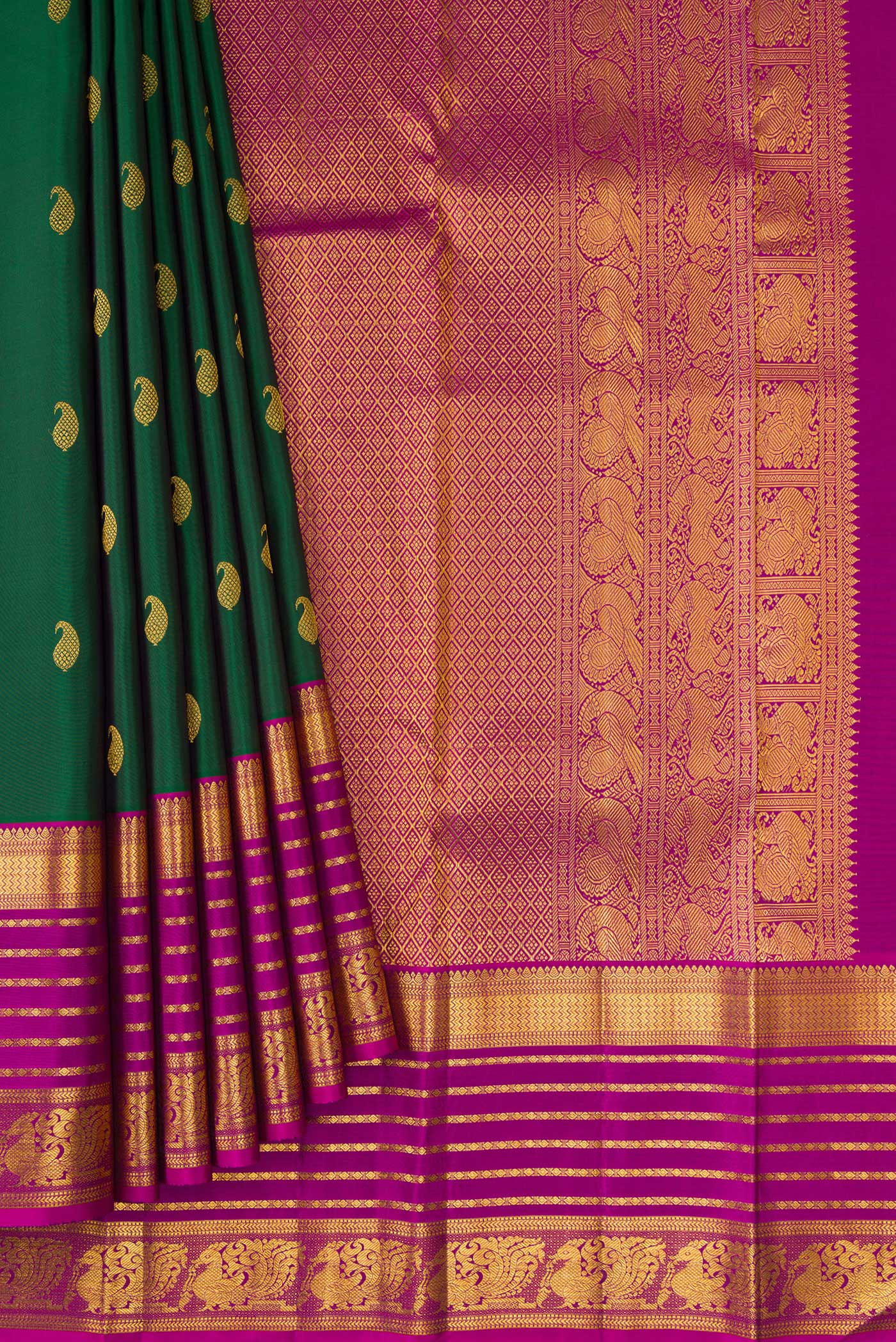 Pleats and pallu of Bottle Green Kanchipuram Silk Saree with Zari Butta on the body and Zari Border. 