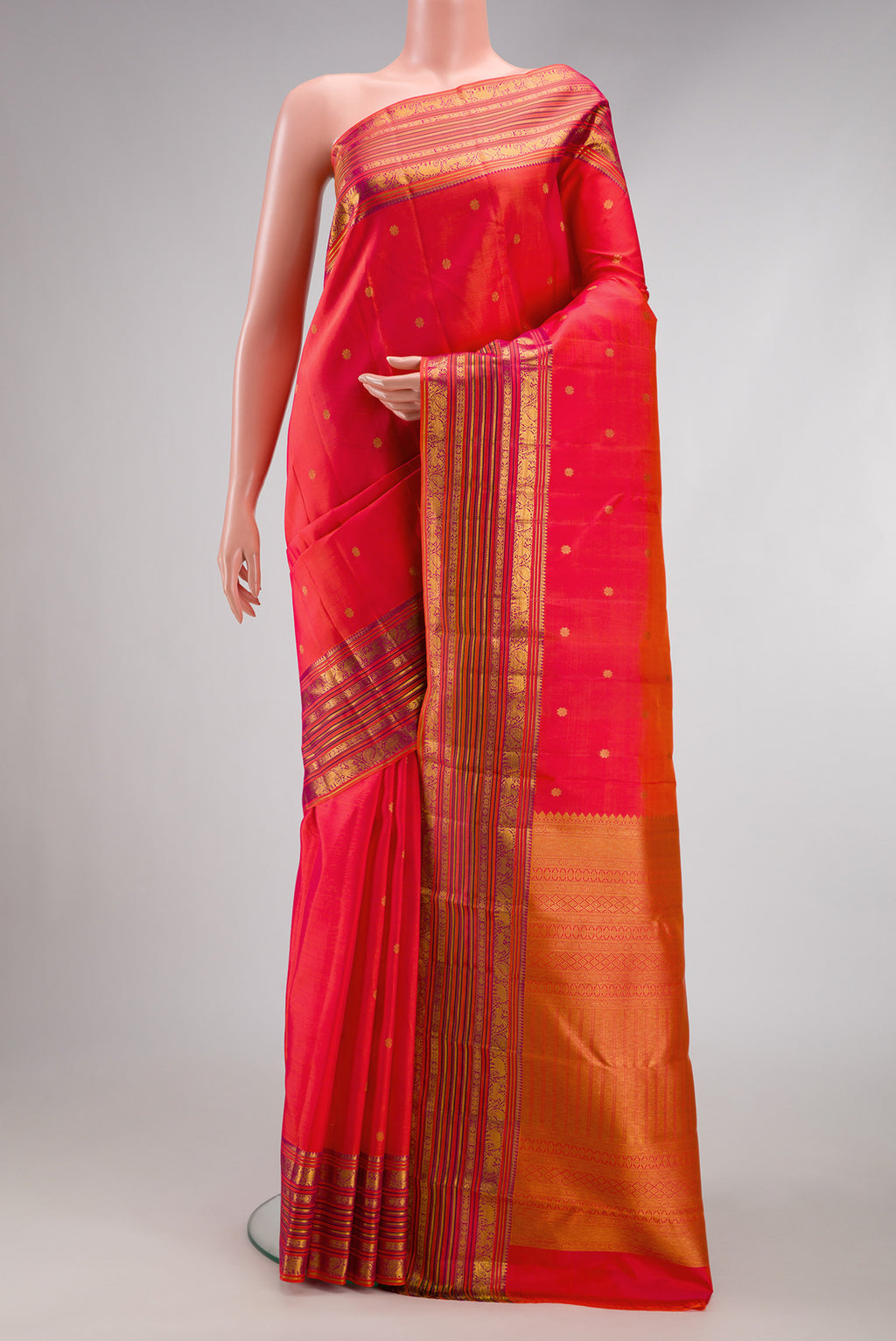 Coral Dual Tone Kanchipuram Silk Saree with Zari Butta on the body and Fancy Border.  displayed on a mannequin