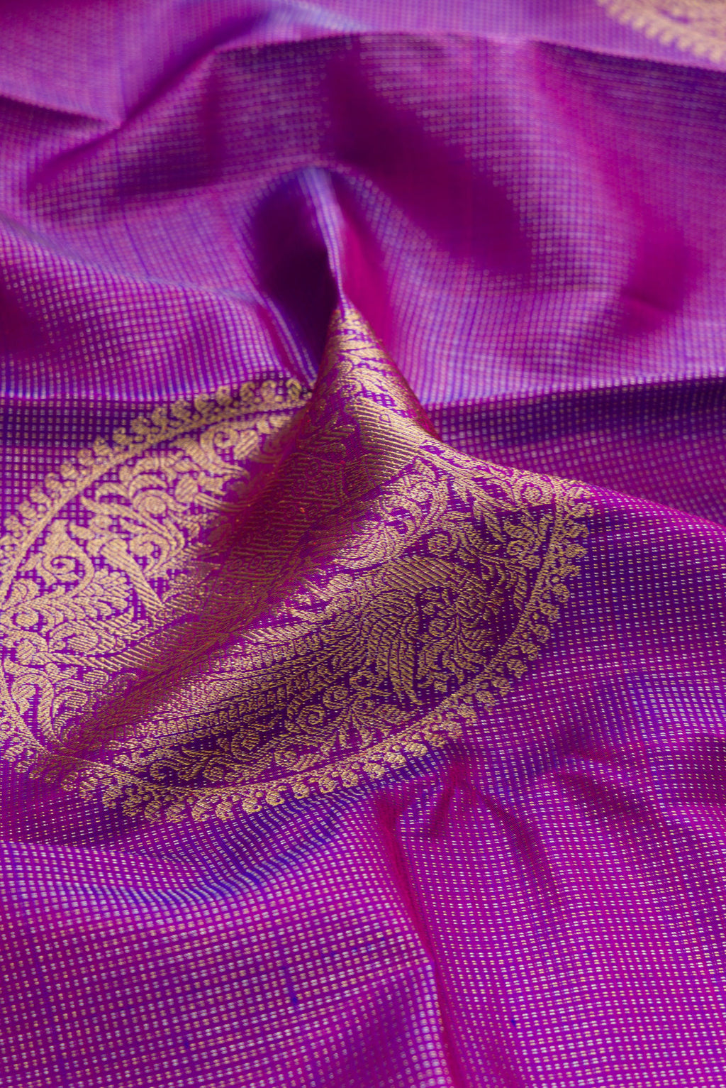 Close up of Purple Kanjivaram Silk Saree with Zari Butta on the body and Without Border.  displaying folds