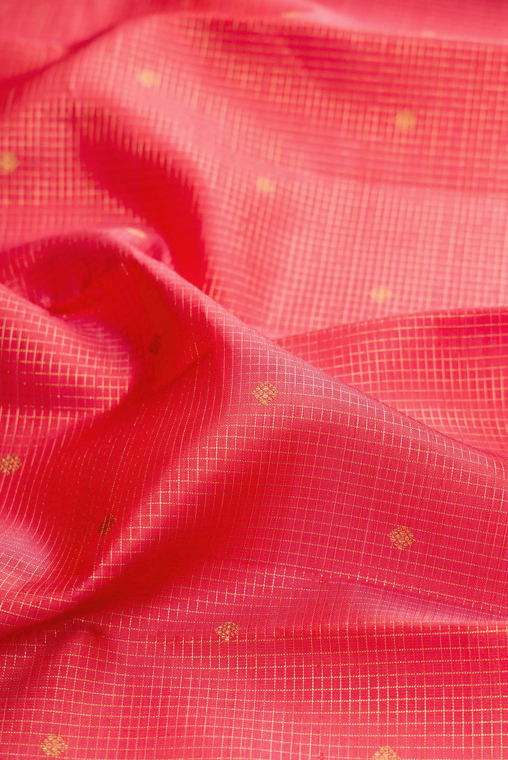 Close up of Pure Silk Pure Zari Coral Dual Tone Kanjivaram Saree with Checked design on the body and Zari Border.  displaying folds