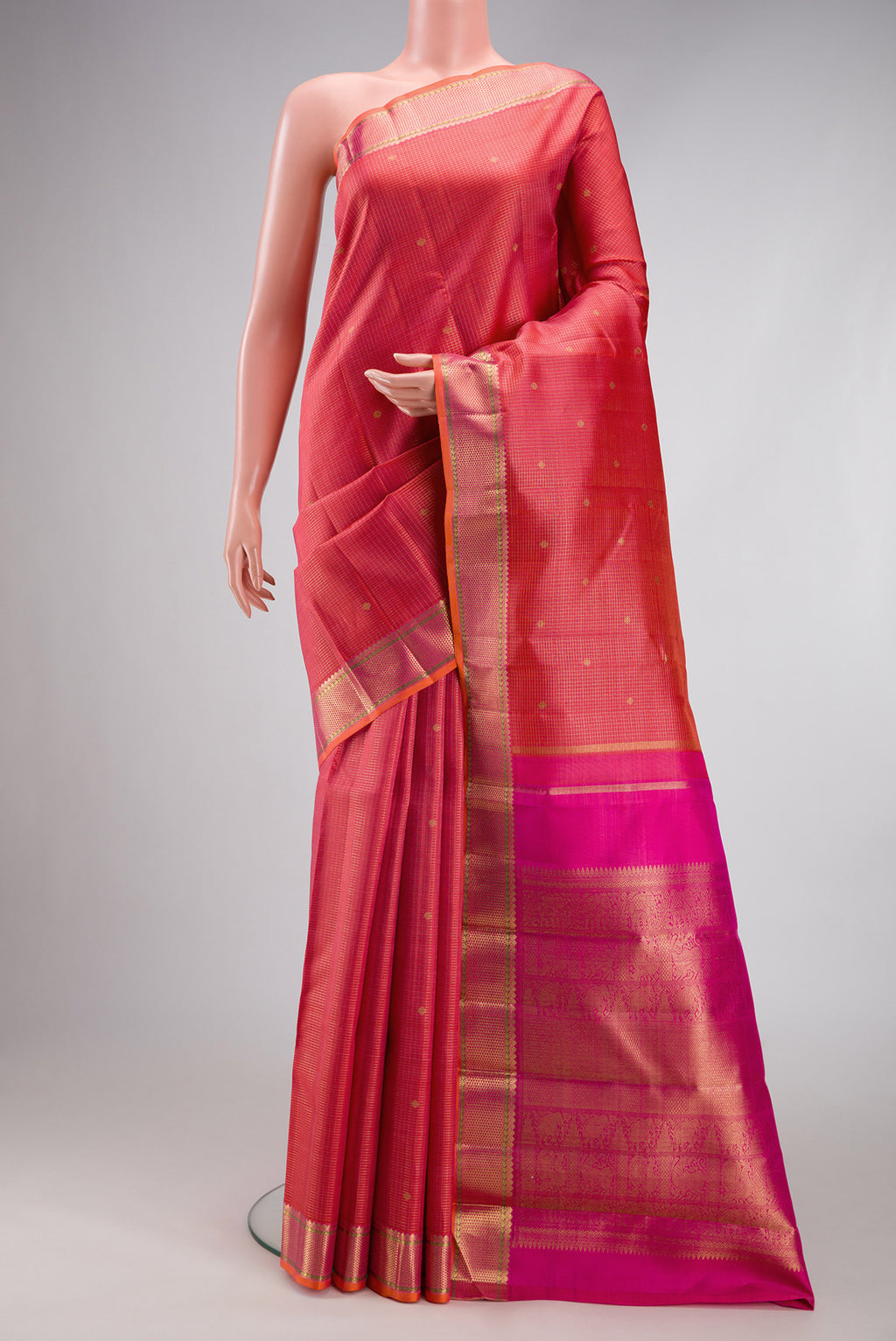 Pure Silk Pure Zari Coral Dual Tone Kanjivaram Saree with Checked design on the body and Zari Border.  displayed on a mannequin