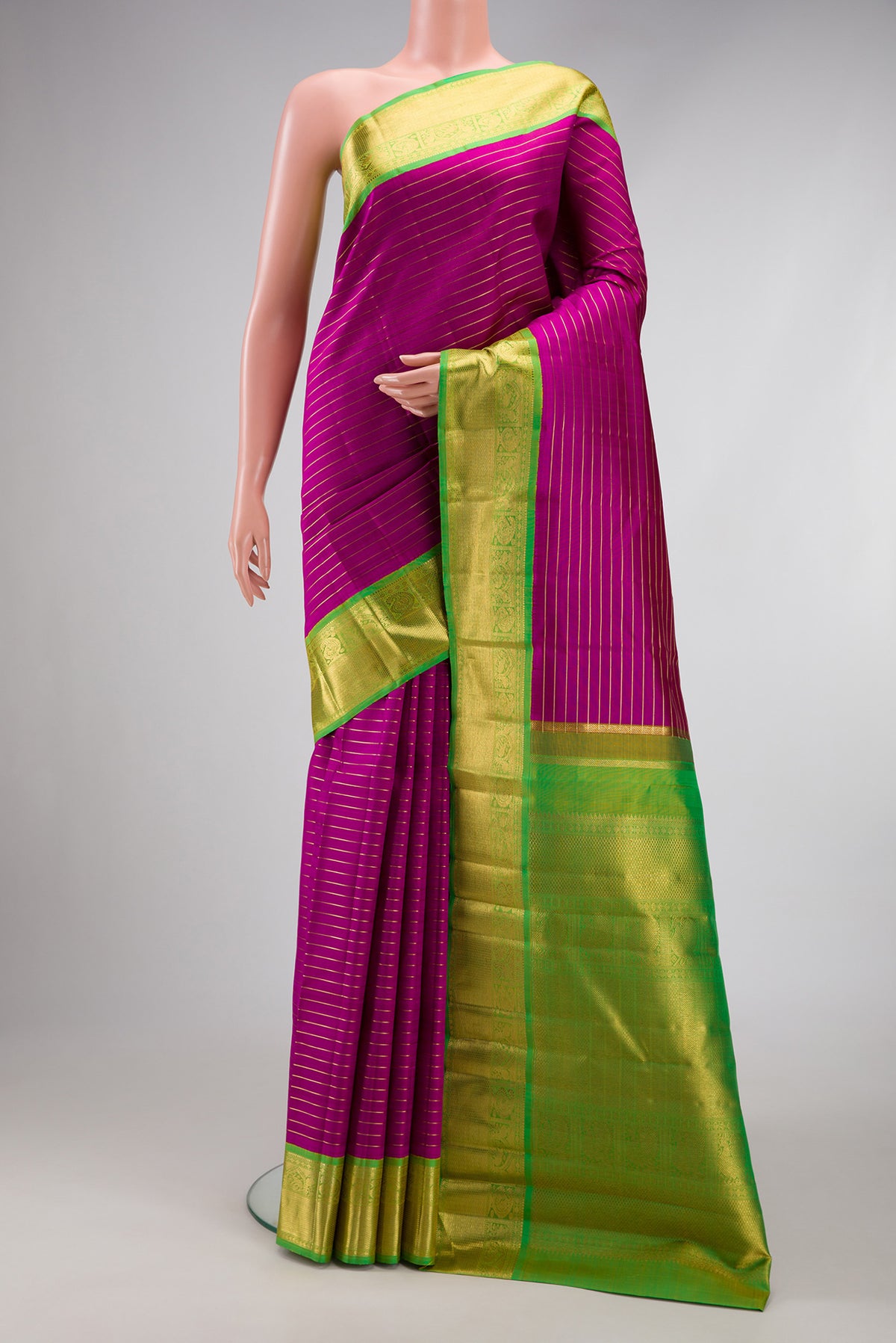 Pure Silk Pure Zari Magenta Dual Tone Kanjivaram Saree with Stripes on the body and Zari Border.  displayed on a mannequin