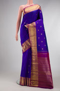 Pure Silk Pure Zari Royal Blue Kanjivaram Saree with Zari Butta on the body and Zari Border.  displayed on a mannequin
