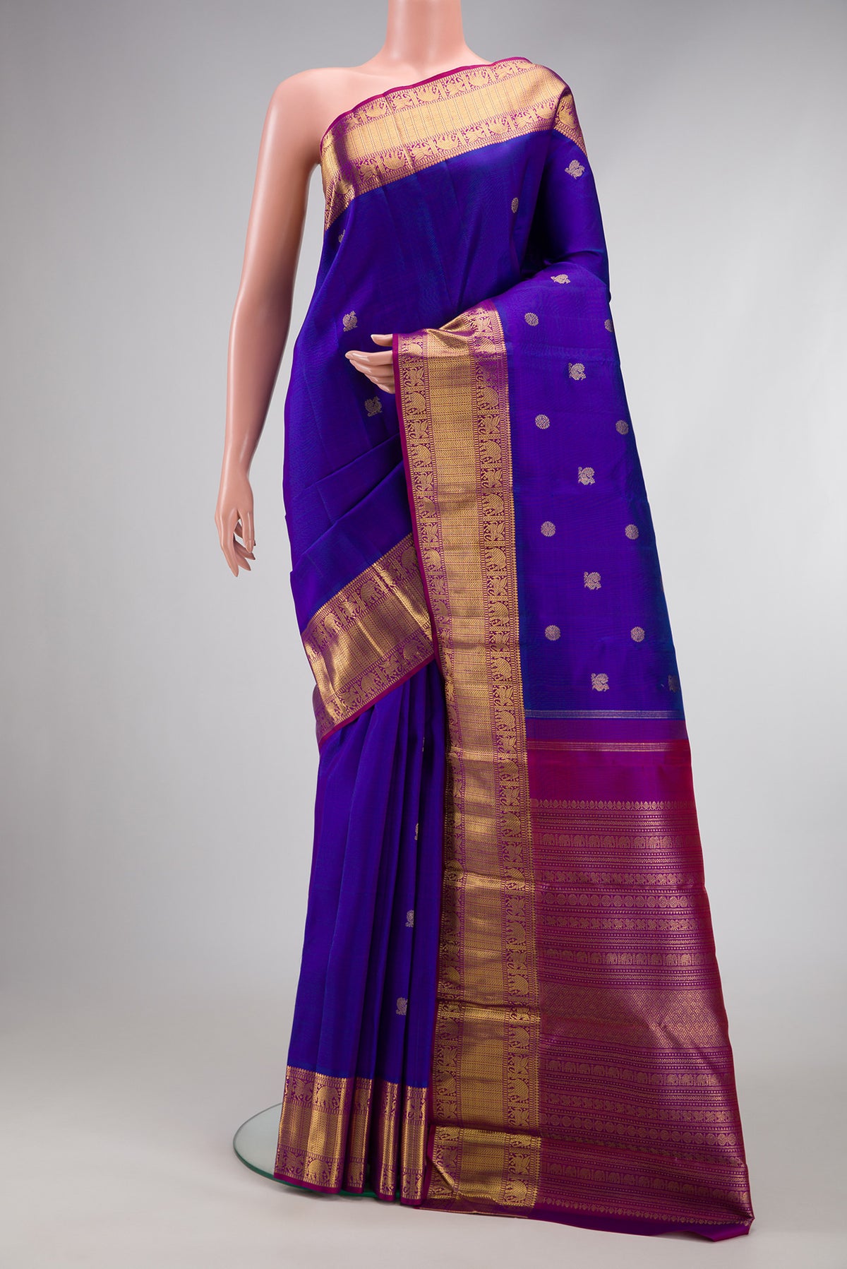 Pure Silk Pure Zari Royal Blue Kanjivaram Saree with Zari Butta on the body and Zari Border.  displayed on a mannequin
