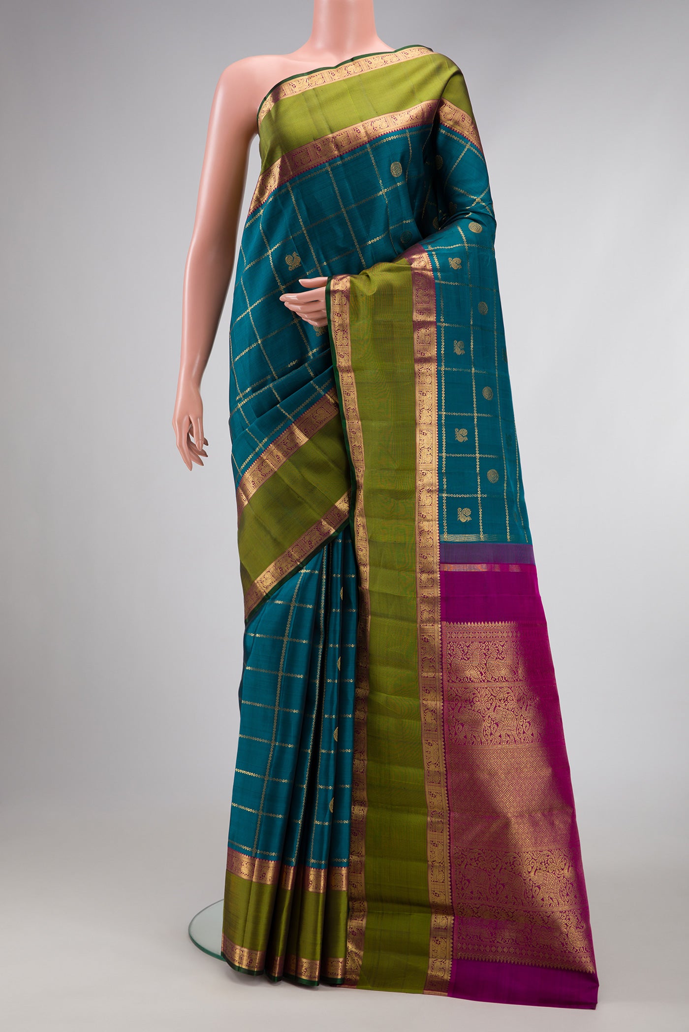 Pure Silk Pure Zari Peacock Blue Dual Tone Kanjivaram Saree with Checked design on the body and Zari Border.  displayed on a mannequin