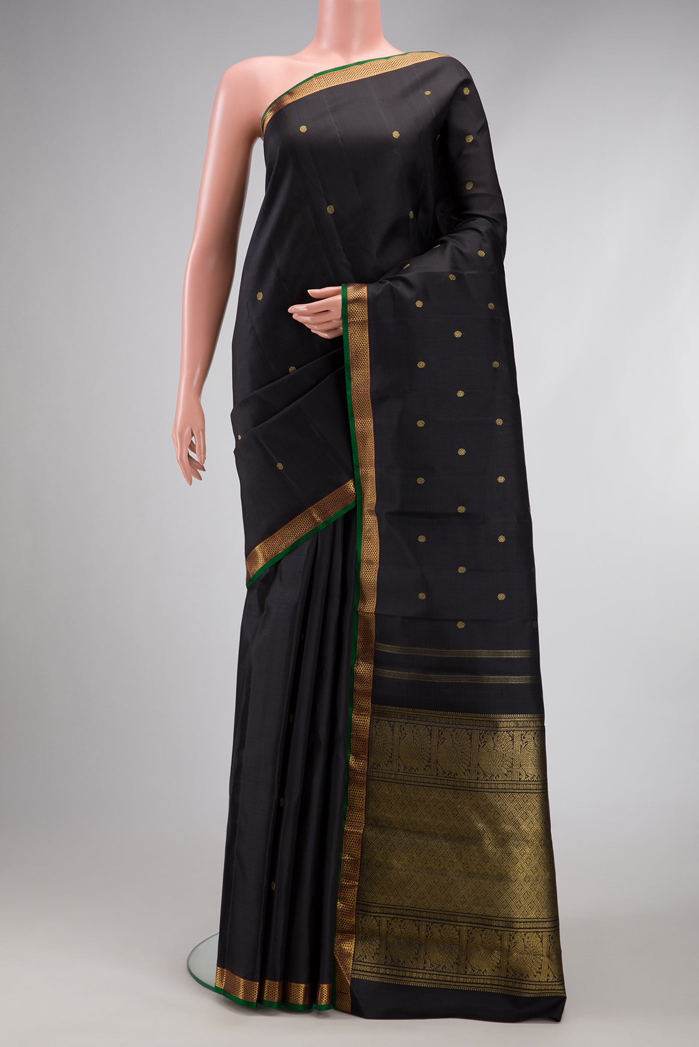 Pure Silk Pure Zari Black Dual Tone Kanchipuram Saree with Zari Butta on the body and Zari Border.  displayed on a mannequin