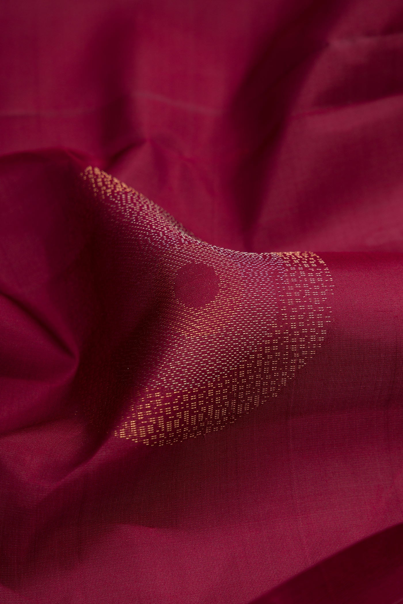 Close up of Maroon Soft Silk Saree with Zari Butta on the body and Without Border.  displaying folds