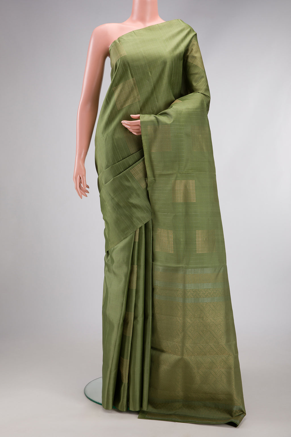 Sage Green Soft Silk Saree with Zari Butta on the body and Without Border.  displayed on a mannequin