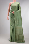 Pista Green Soft Silk Saree with Zari Butta on the body and Without Border.  displayed on a mannequin