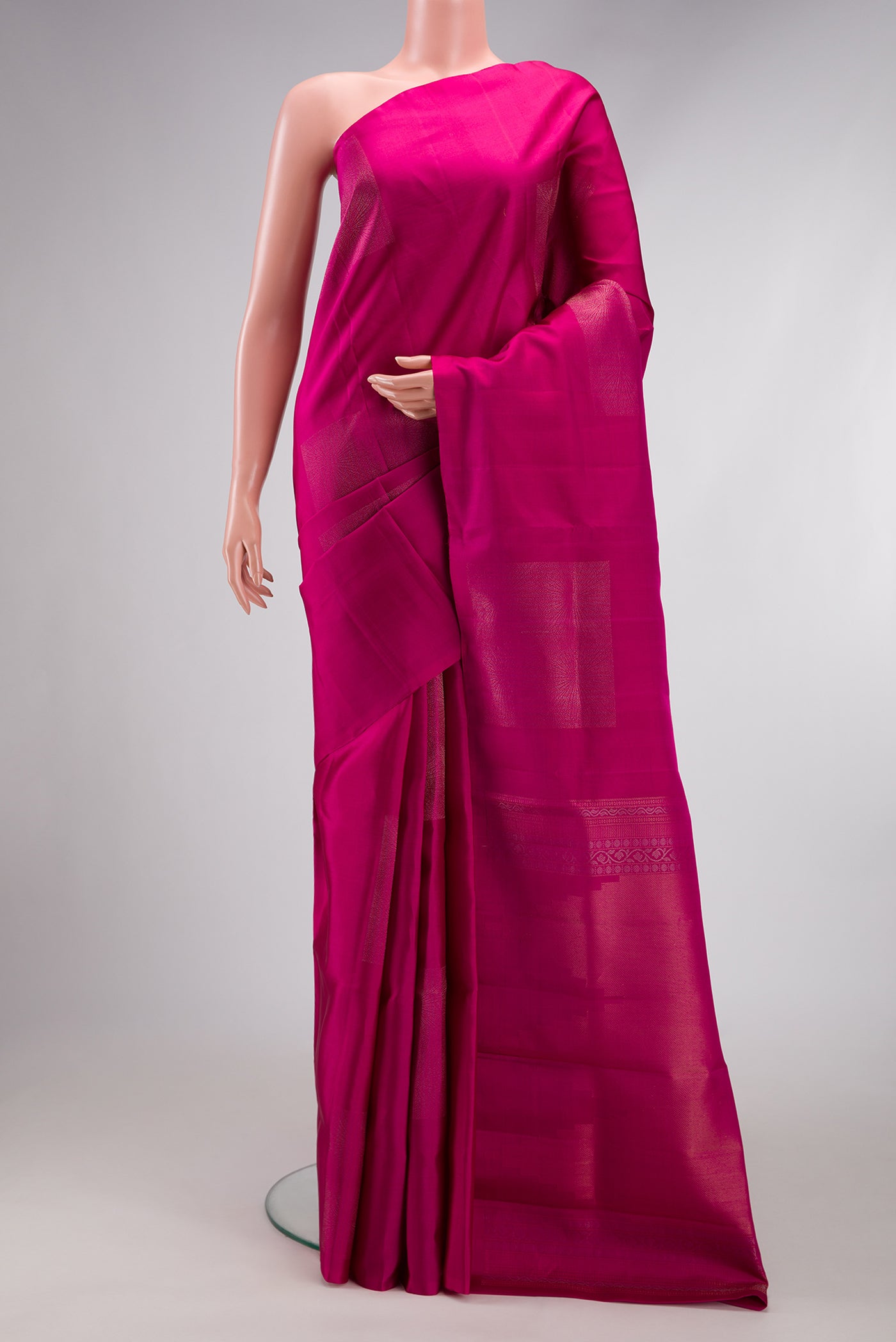 Dark Pink Soft Silk Saree with Zari Butta on the body and Without Border.  displayed on a mannequin