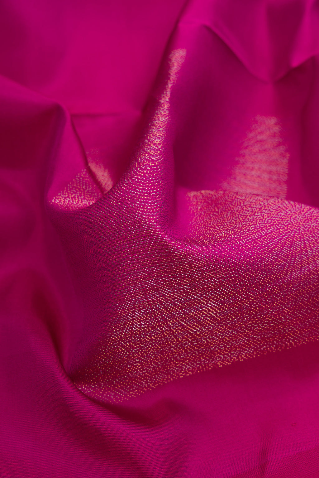 Close up of Magenta Soft Silk Saree with Zari Butta on the body and Without Border.  displaying folds