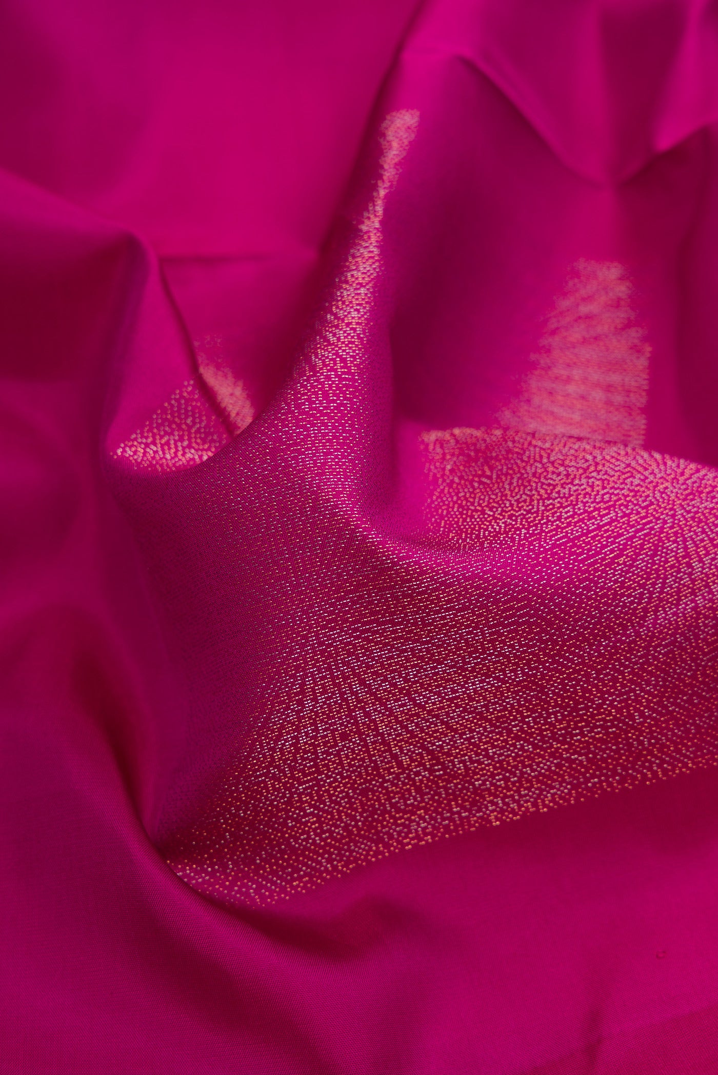 Close up of Magenta Soft Silk Saree with Zari Butta on the body and Without Border.  displaying folds