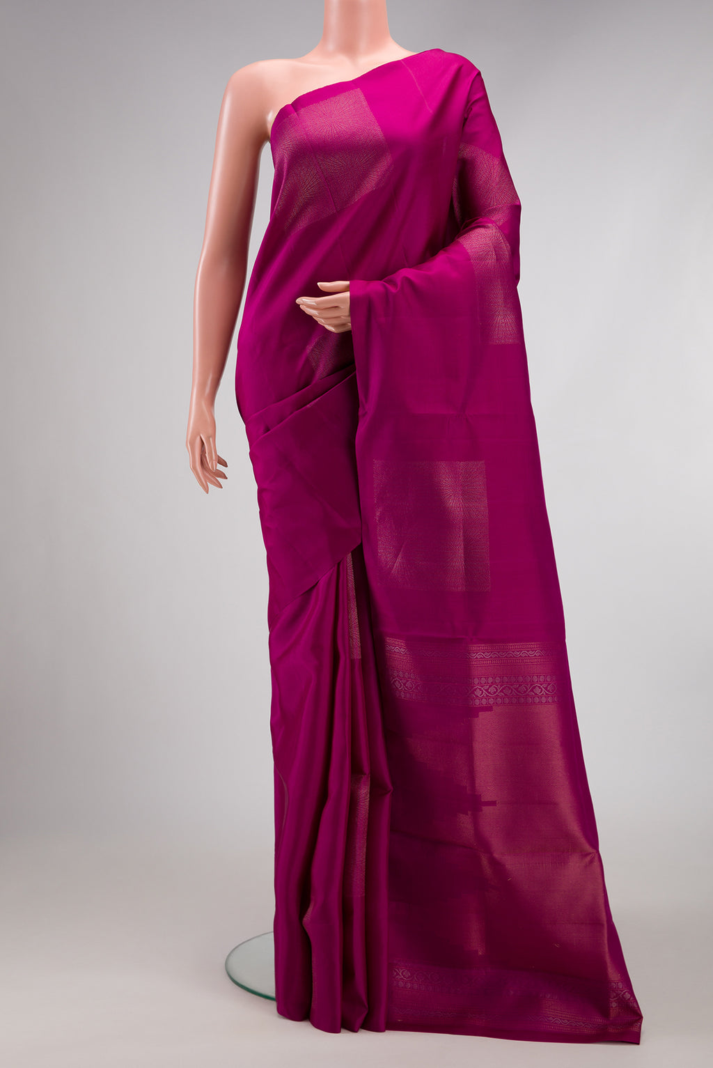 Magenta Soft Silk Saree with Zari Butta on the body and Without Border.  displayed on a mannequin