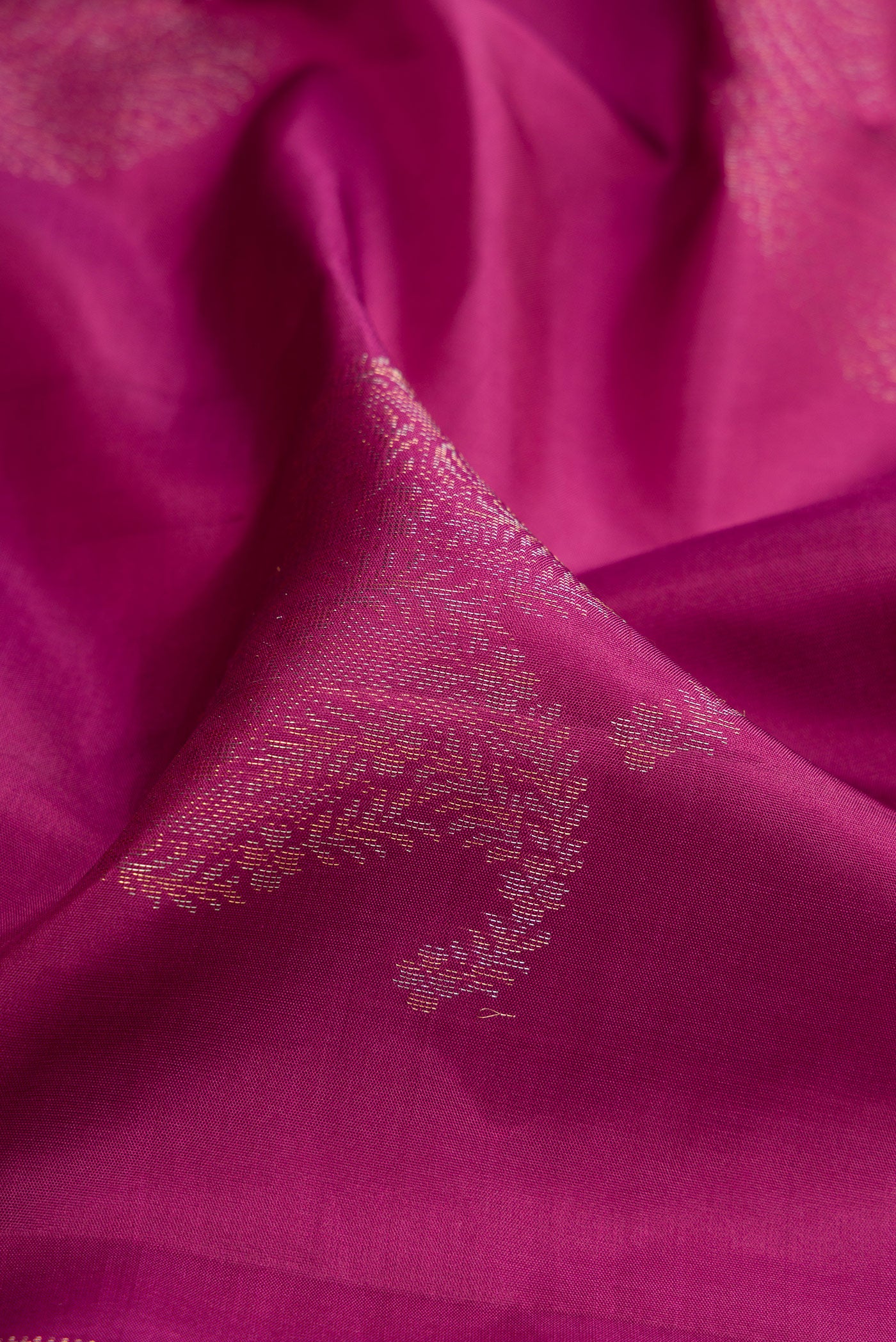 Close up of Magenta Soft Silk Saree with Zari Butta on the body and Without Border.  displaying folds