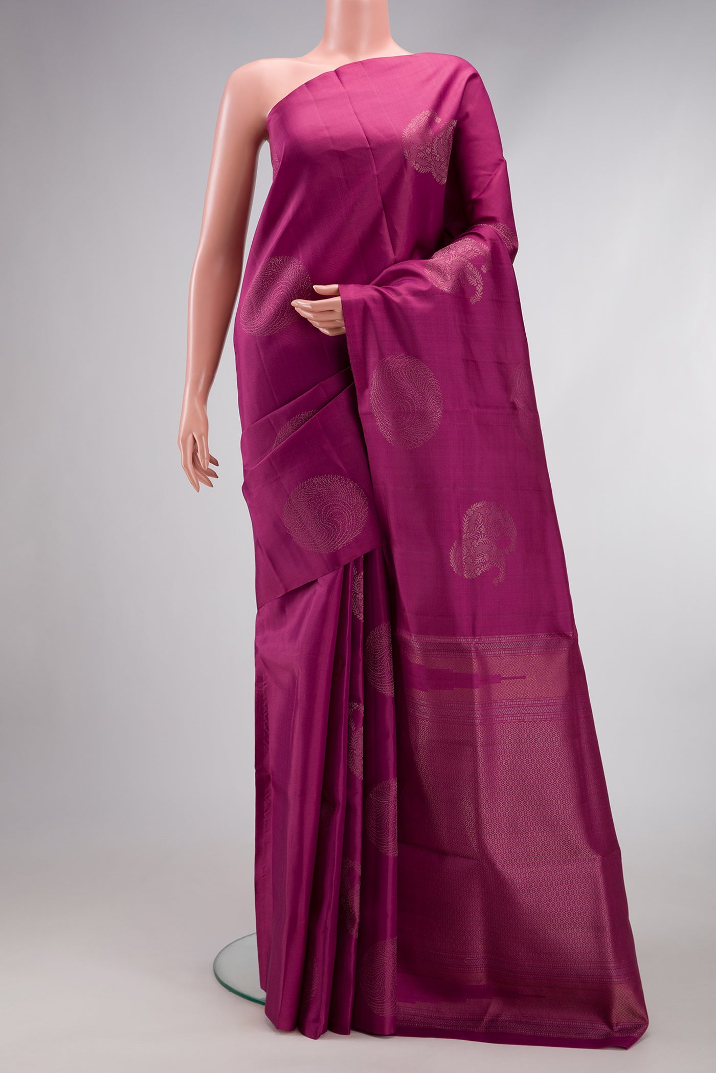 Magenta Soft Silk Saree with Zari Butta on the body and Without Border.  displayed on a mannequin