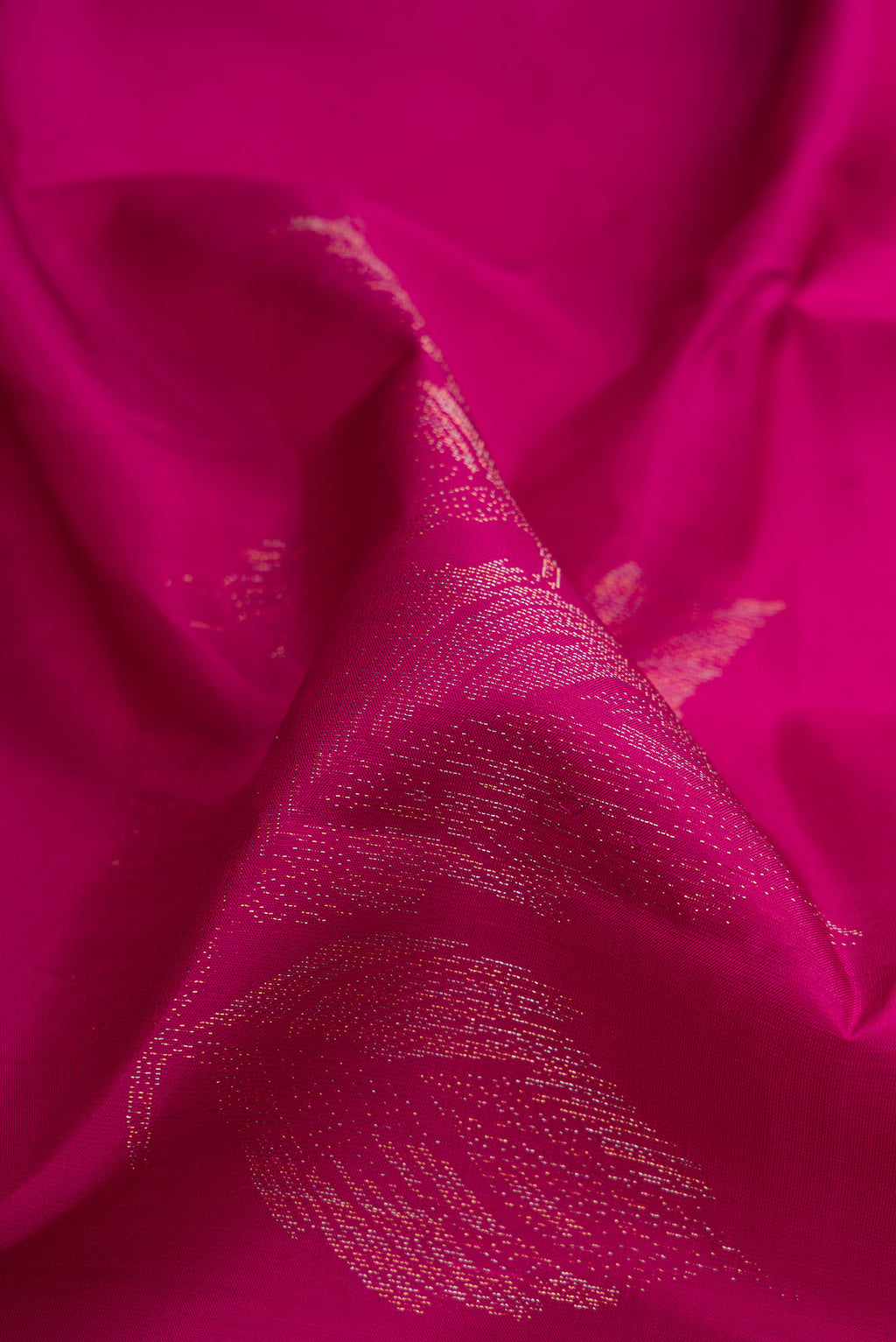 Close up of Magenta Soft Silk Saree with Zari Butta on the body and Without Border.  displaying folds