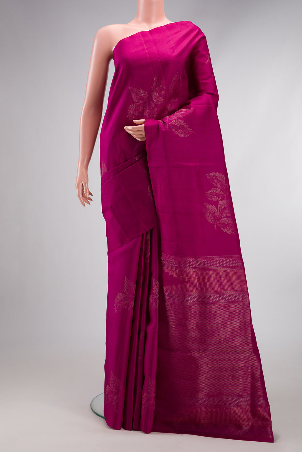 Magenta Soft Silk Saree with Zari Butta on the body and Without Border.  displayed on a mannequin