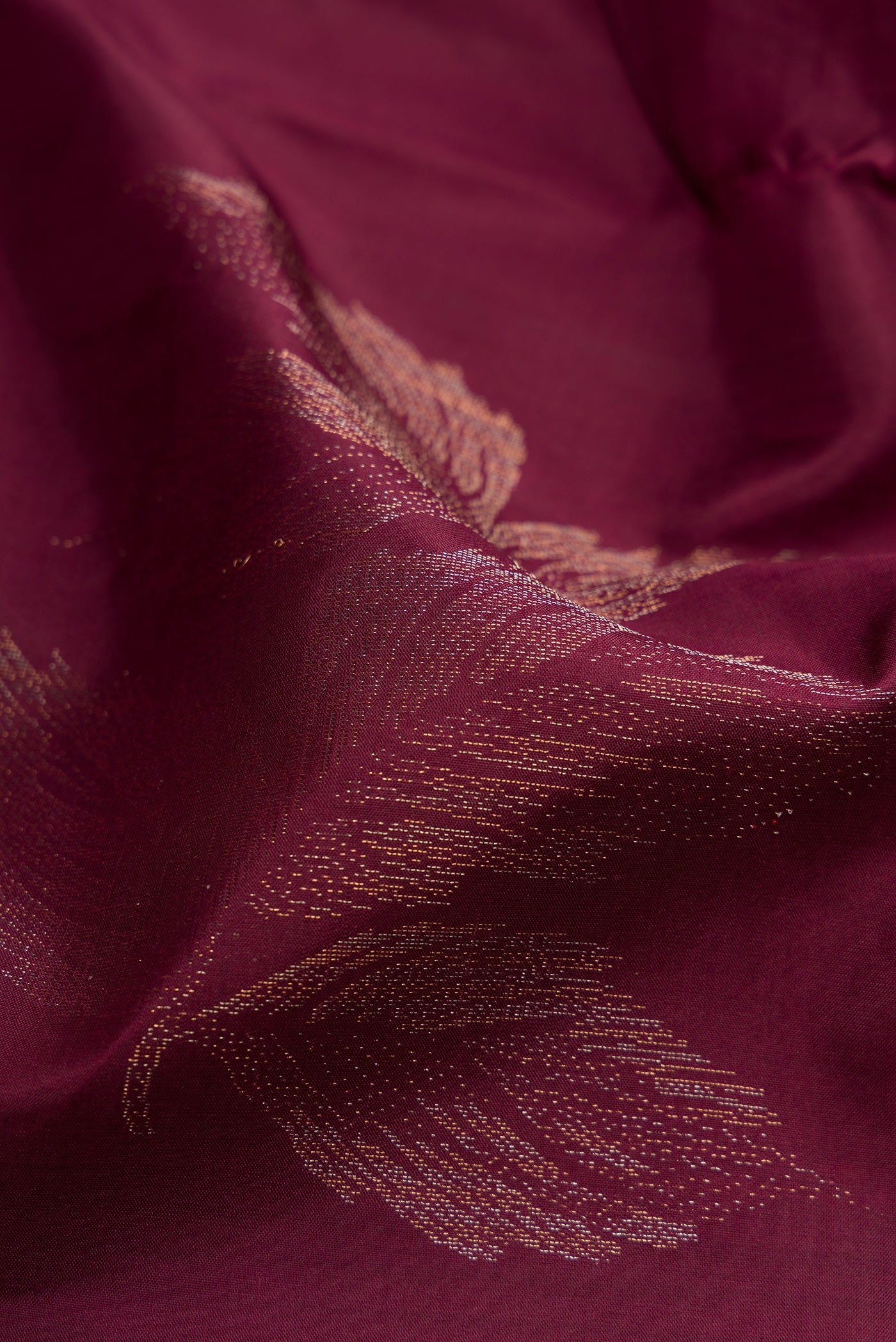 Close up of Burgundy Soft Silk Saree with Zari Butta on the body and Without Border.  displaying folds