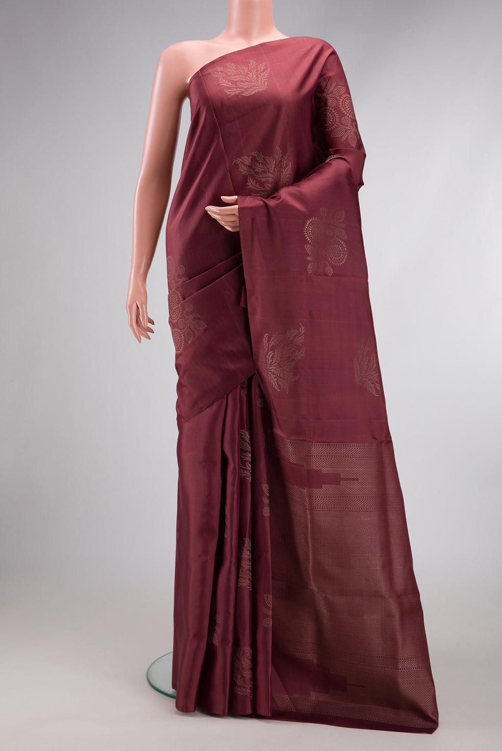 Dark Mauve Soft Silk Saree with Zari Butta on the body and Without Border.  displayed on a mannequin