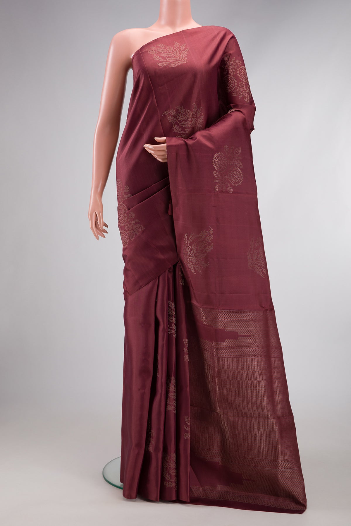 Dark Mauve Soft Silk Saree with Zari Butta on the body and Without Border.  displayed on a mannequin