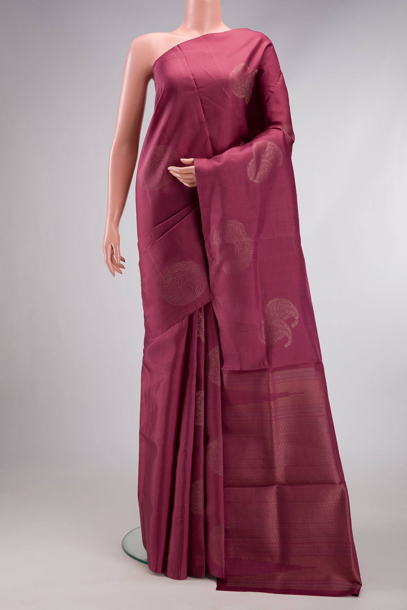 Mauve Soft Silk Saree with Zari Butta on the body and Without Border.  displayed on a mannequin