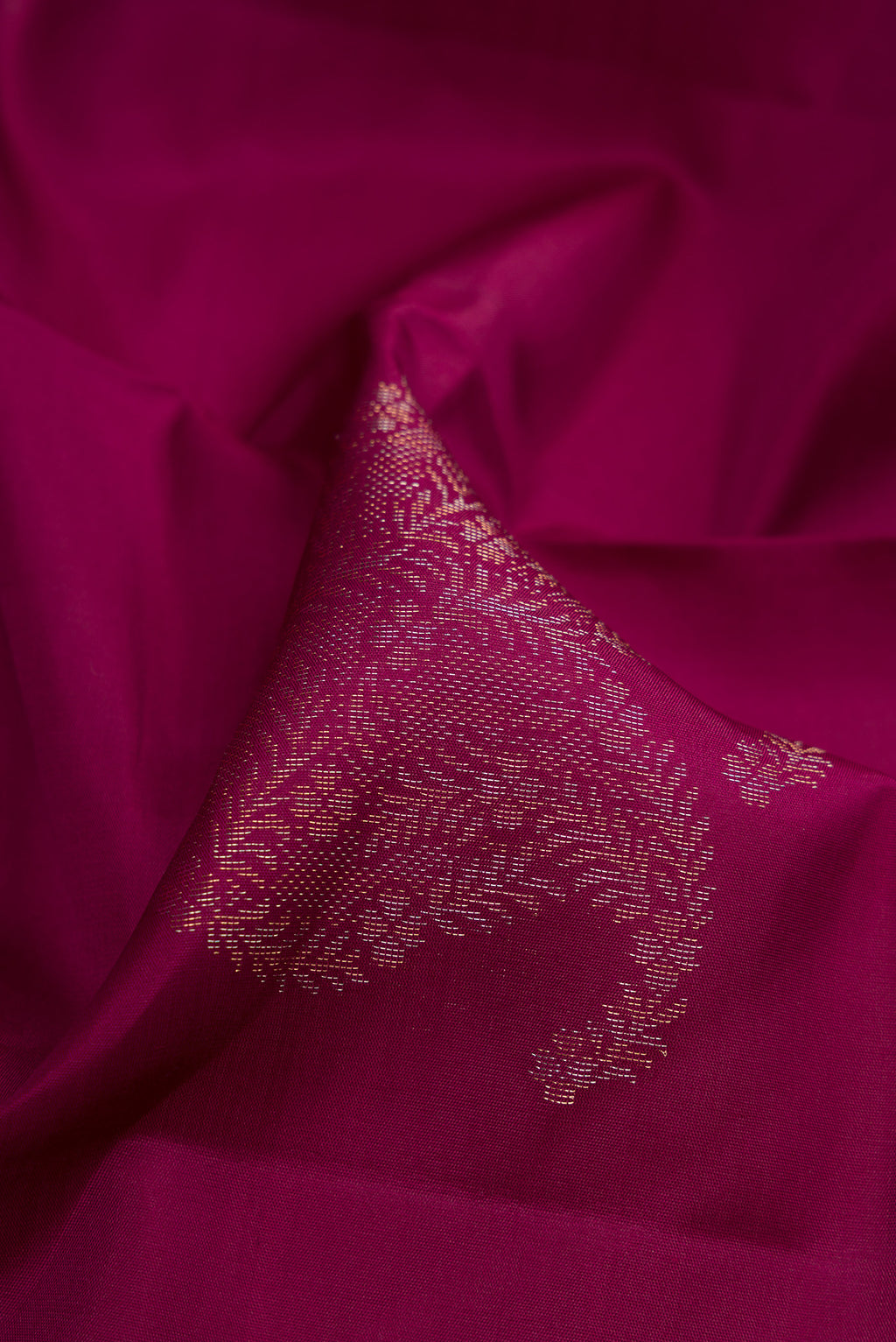Close up of Burgundy Soft Silk Saree with Zari Butta on the body and Without Border.  displaying folds