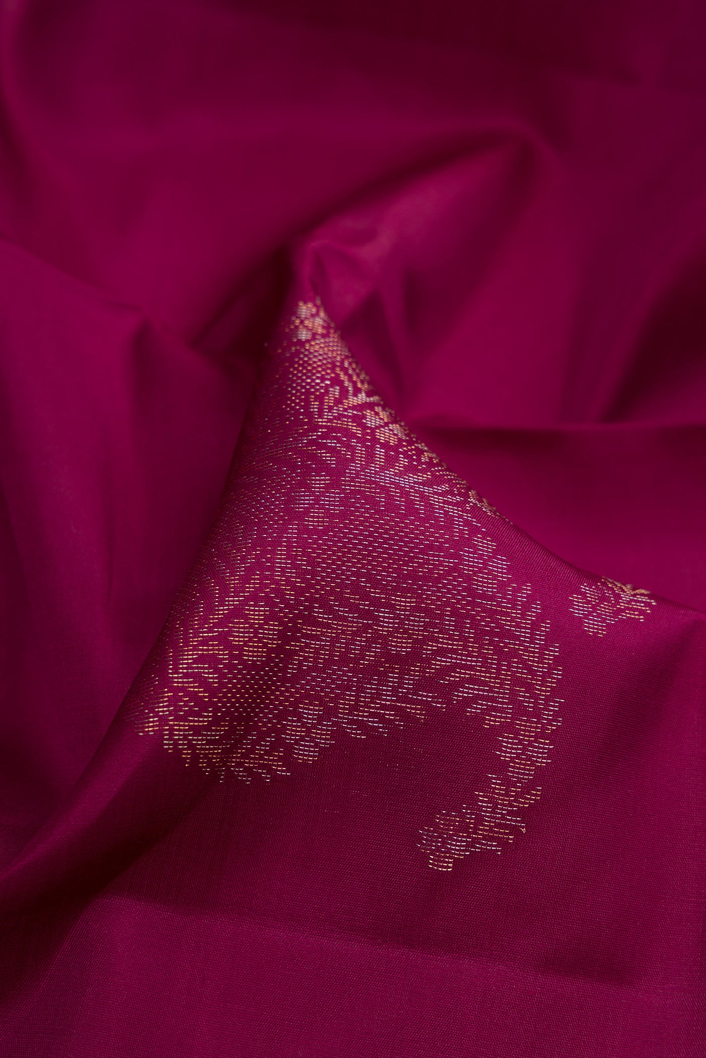 Close up of Burgundy Soft Silk Saree with Zari Butta on the body and Without Border.  displaying folds