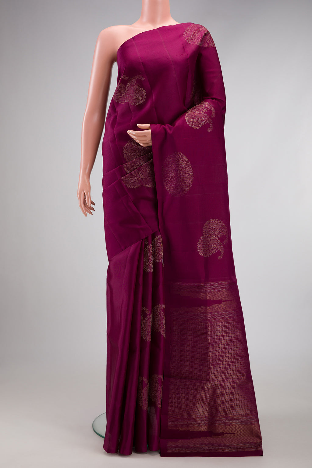 Burgundy Soft Silk Saree with Zari Butta on the body and Without Border.  displayed on a mannequin
