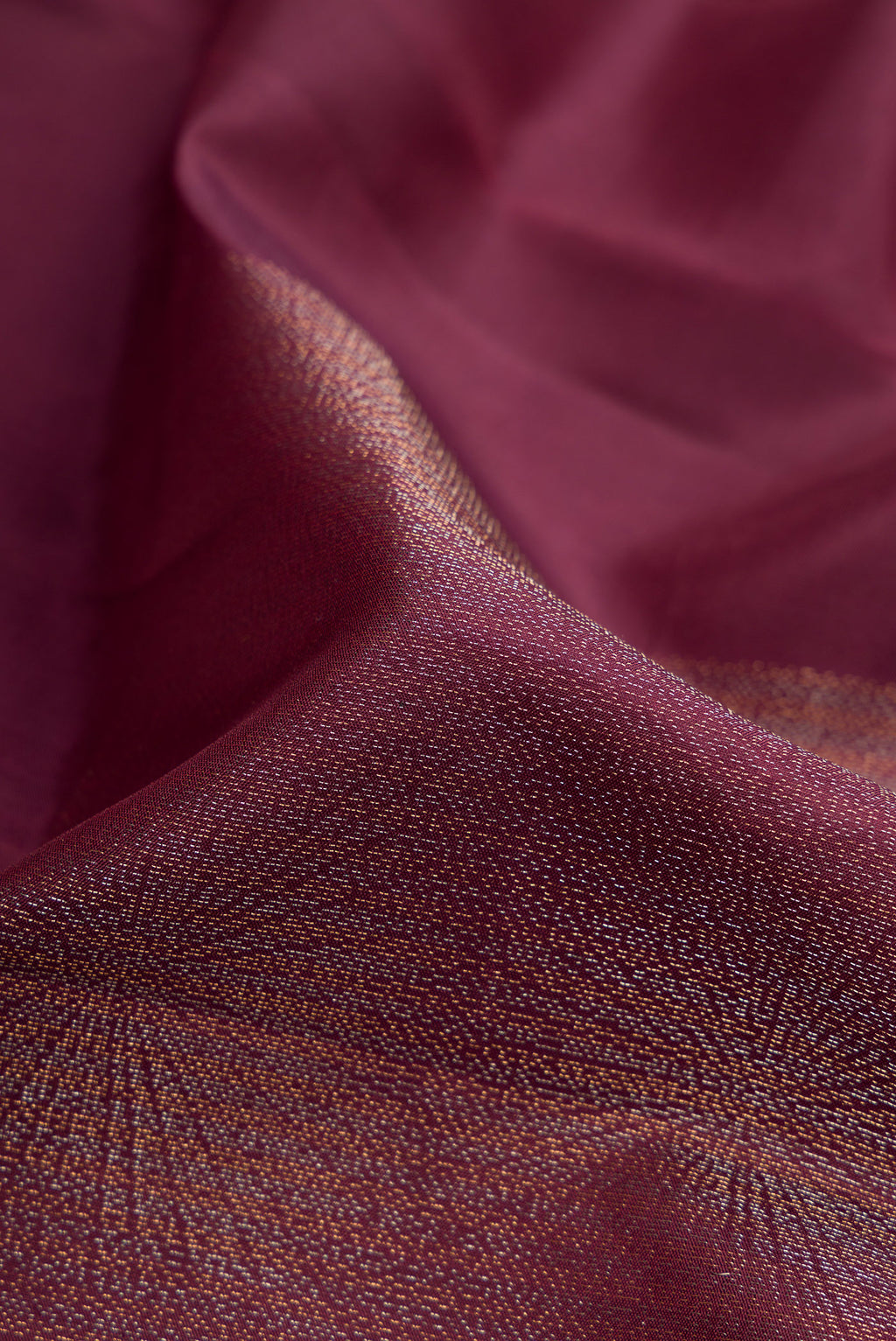 Close up of Coffee Brown Soft Silk Saree with Zari Butta on the body and Without Border.  displaying folds