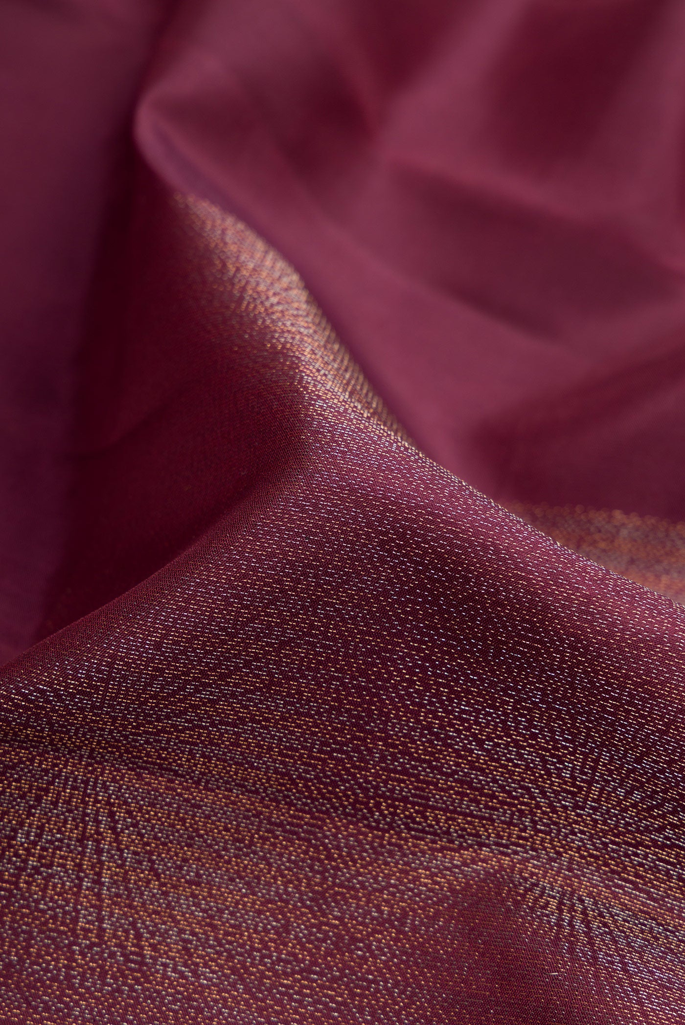 Close up of Coffee Brown Soft Silk Saree with Zari Butta on the body and Without Border.  displaying folds