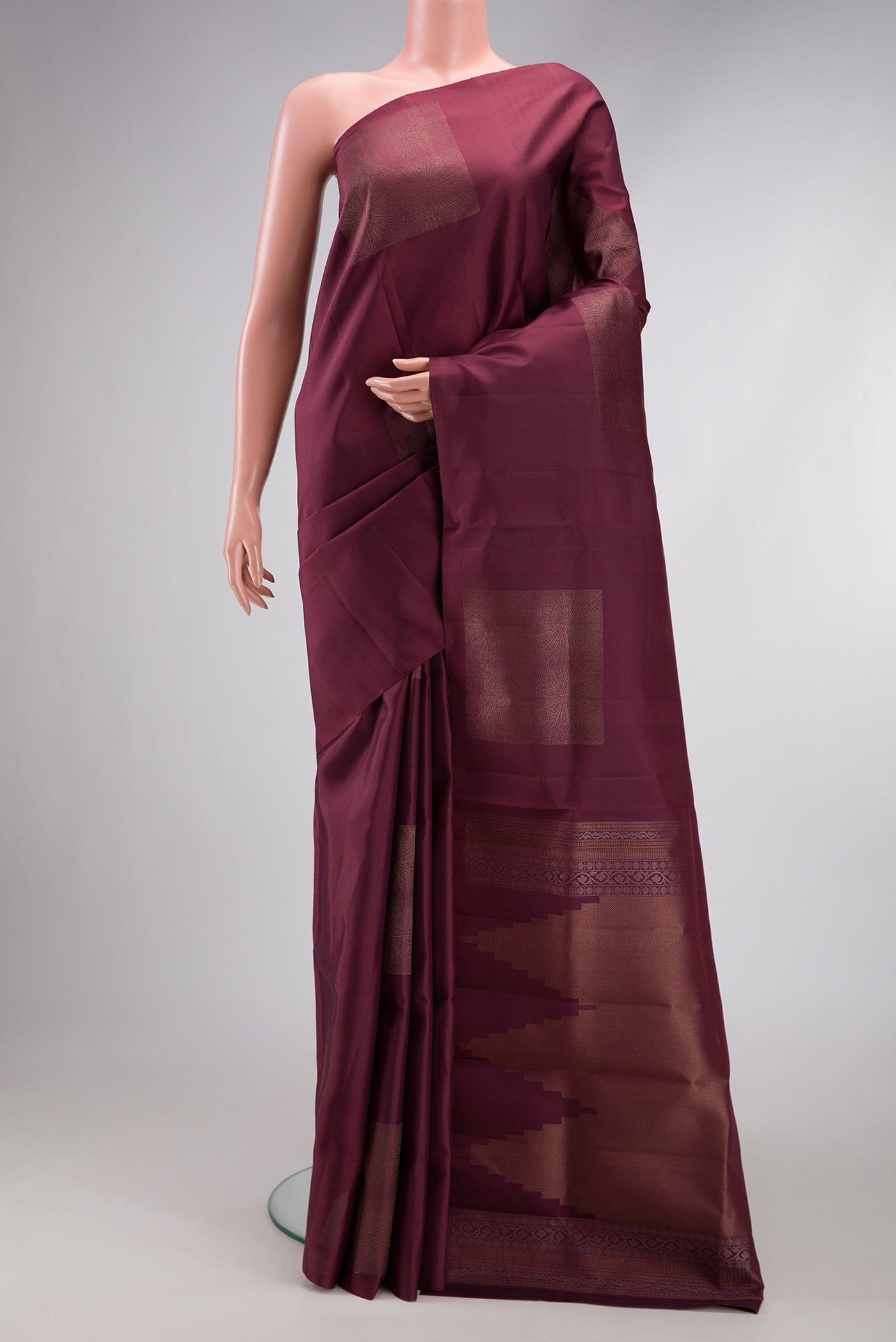Coffee Brown Soft Silk Saree with Zari Butta on the body and Without Border.  displayed on a mannequin