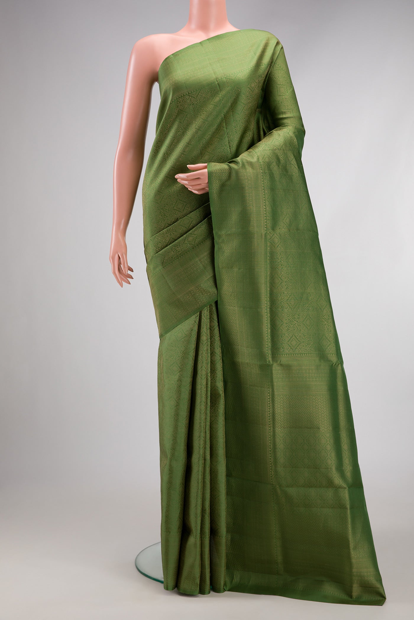 Green Soft Silk Saree with Zari Brocade on the body and Fancy Border.  displayed on a mannequin