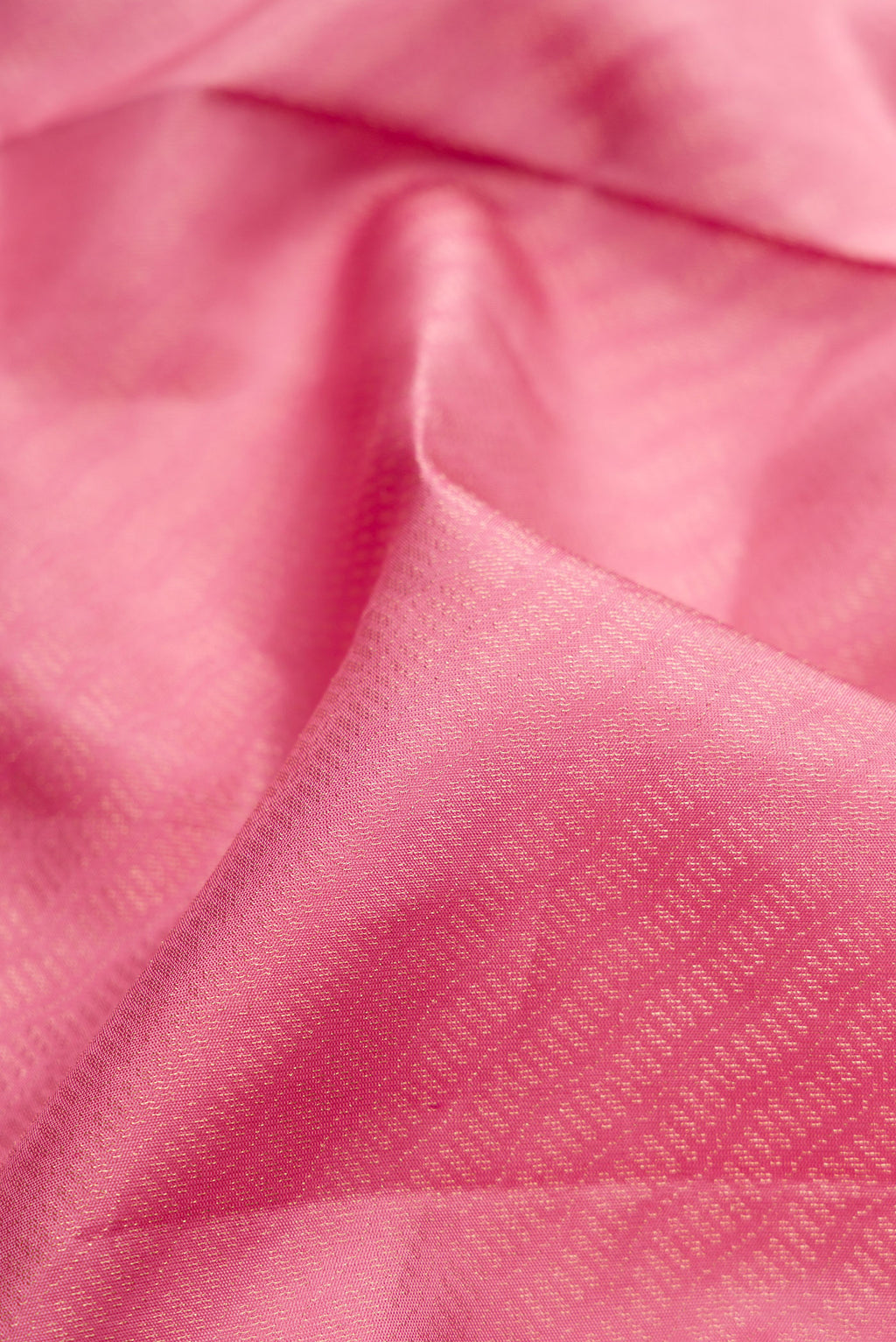 Close up of Rose pink Soft Silk Saree with Zari Brocade on the body and Fancy Border.  displaying folds