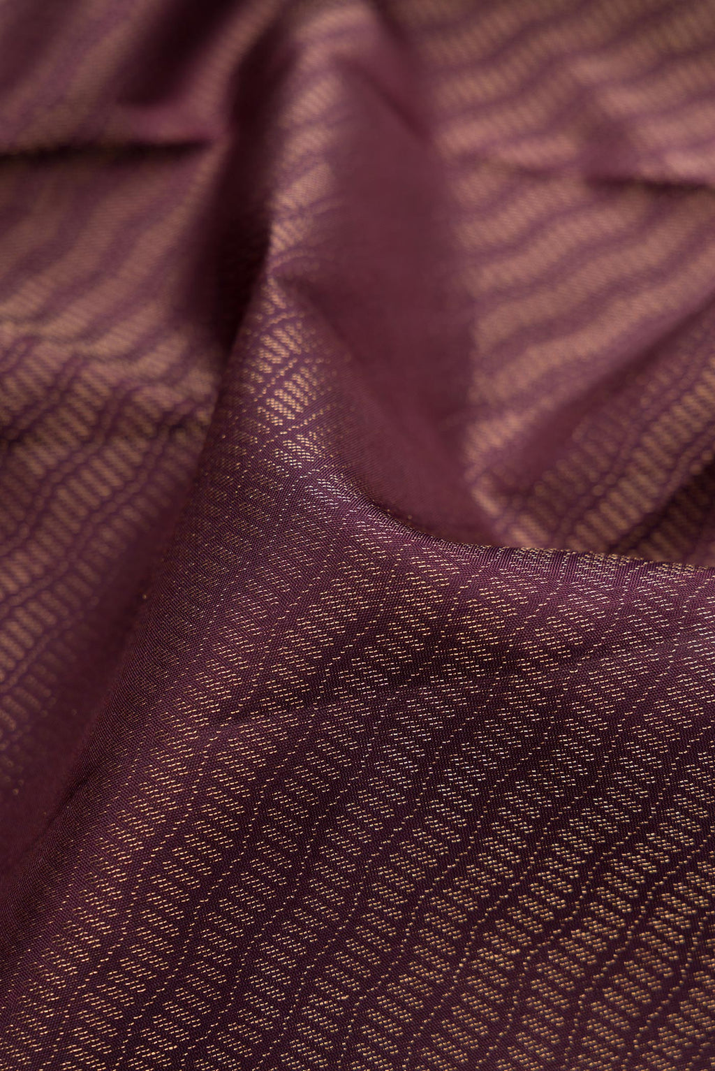 Close up of Burgundy Dual Tone Soft Silk Saree with Zari Brocade on the body and Fancy Border.  displaying folds