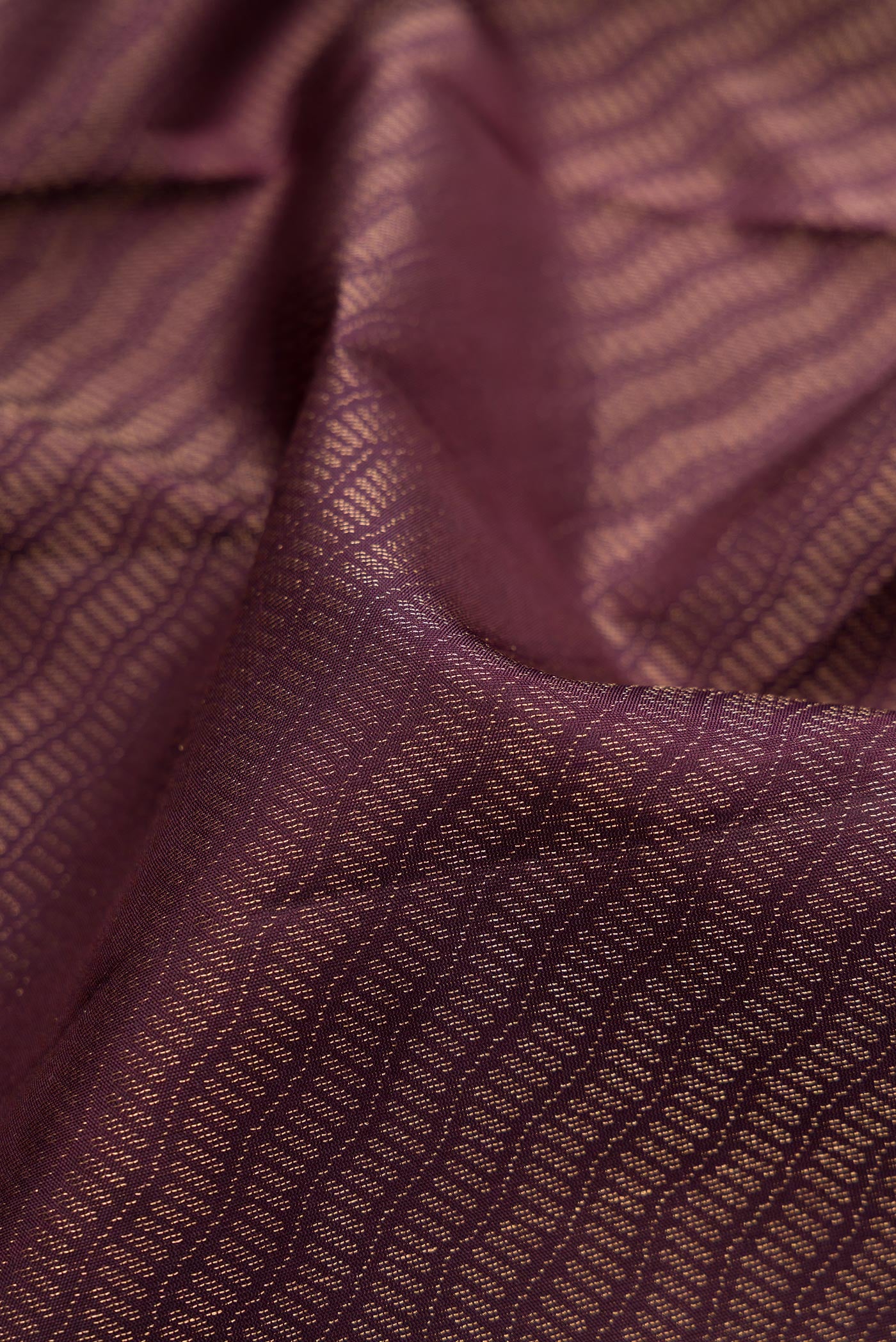 Close up of Burgundy Dual Tone Soft Silk Saree with Zari Brocade on the body and Fancy Border.  displaying folds