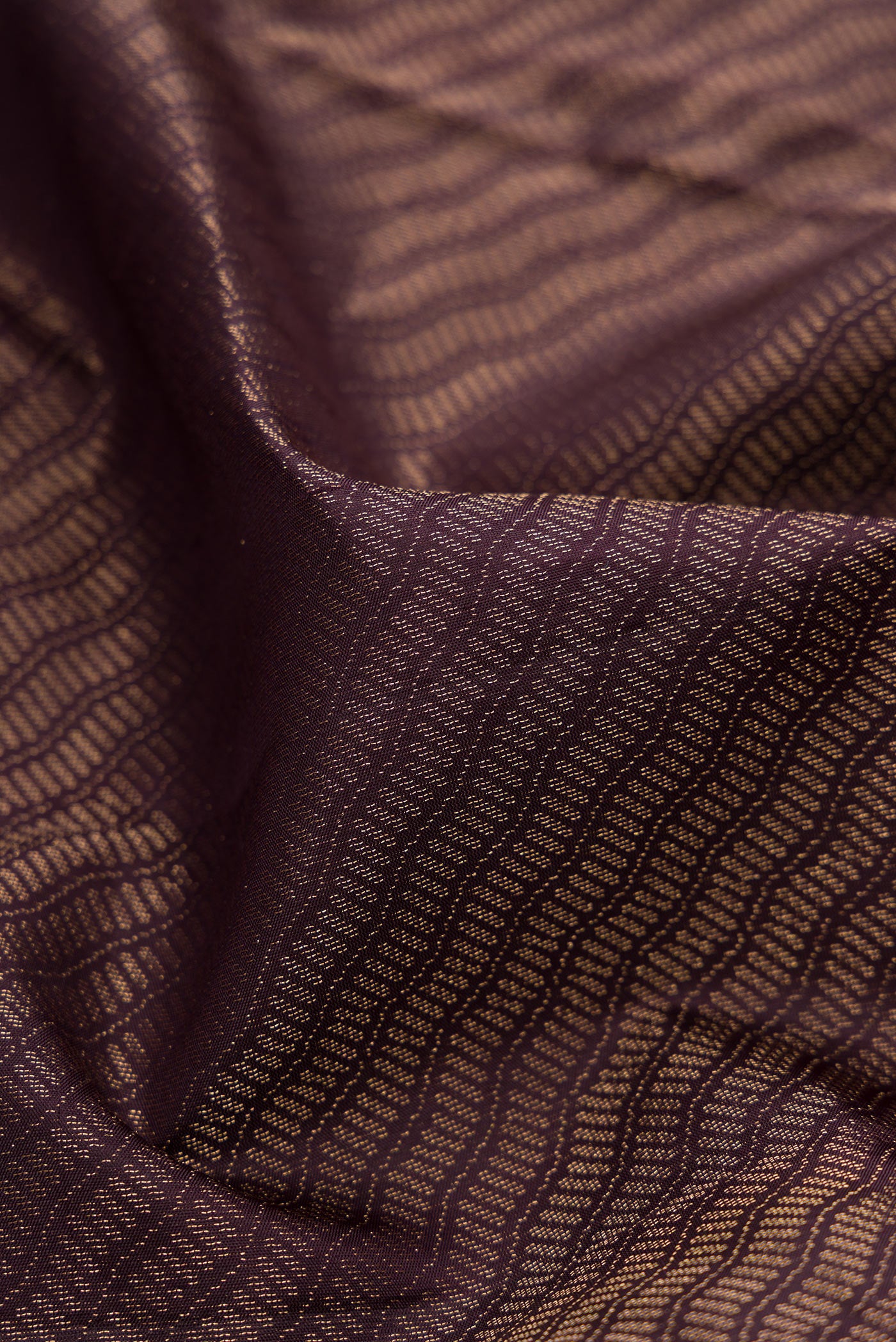 Close up of Burgundy Soft Silk Saree with Zari Brocade on the body and Fancy Border.  displaying folds