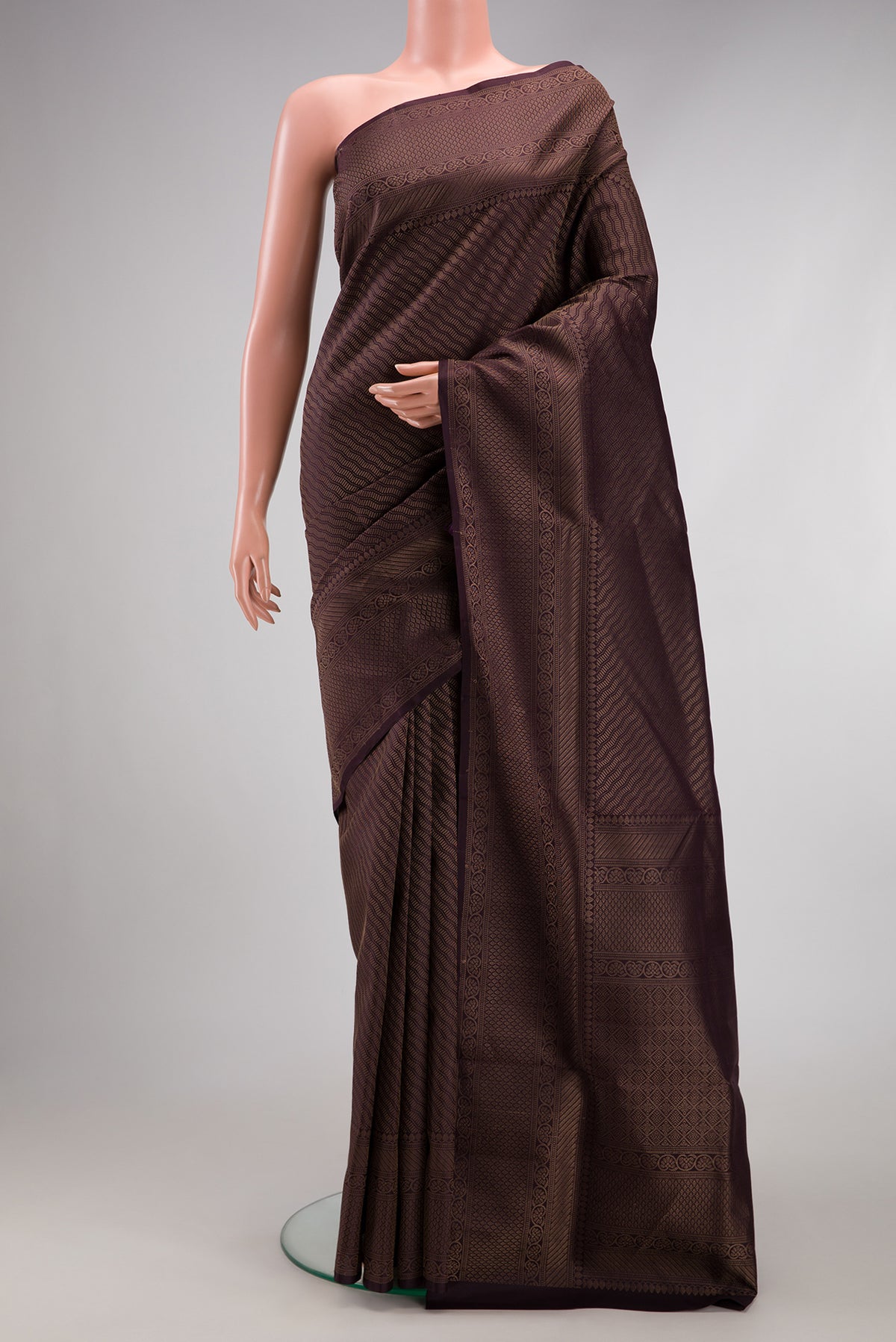 Burgundy Soft Silk Saree with Zari Brocade on the body and Fancy Border.  displayed on a mannequin