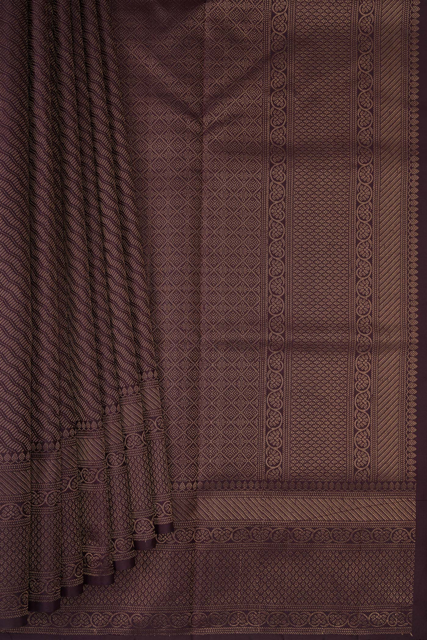 Pleats and pallu of Burgundy Soft Silk Saree with Zari Brocade on the body and Fancy Border. 