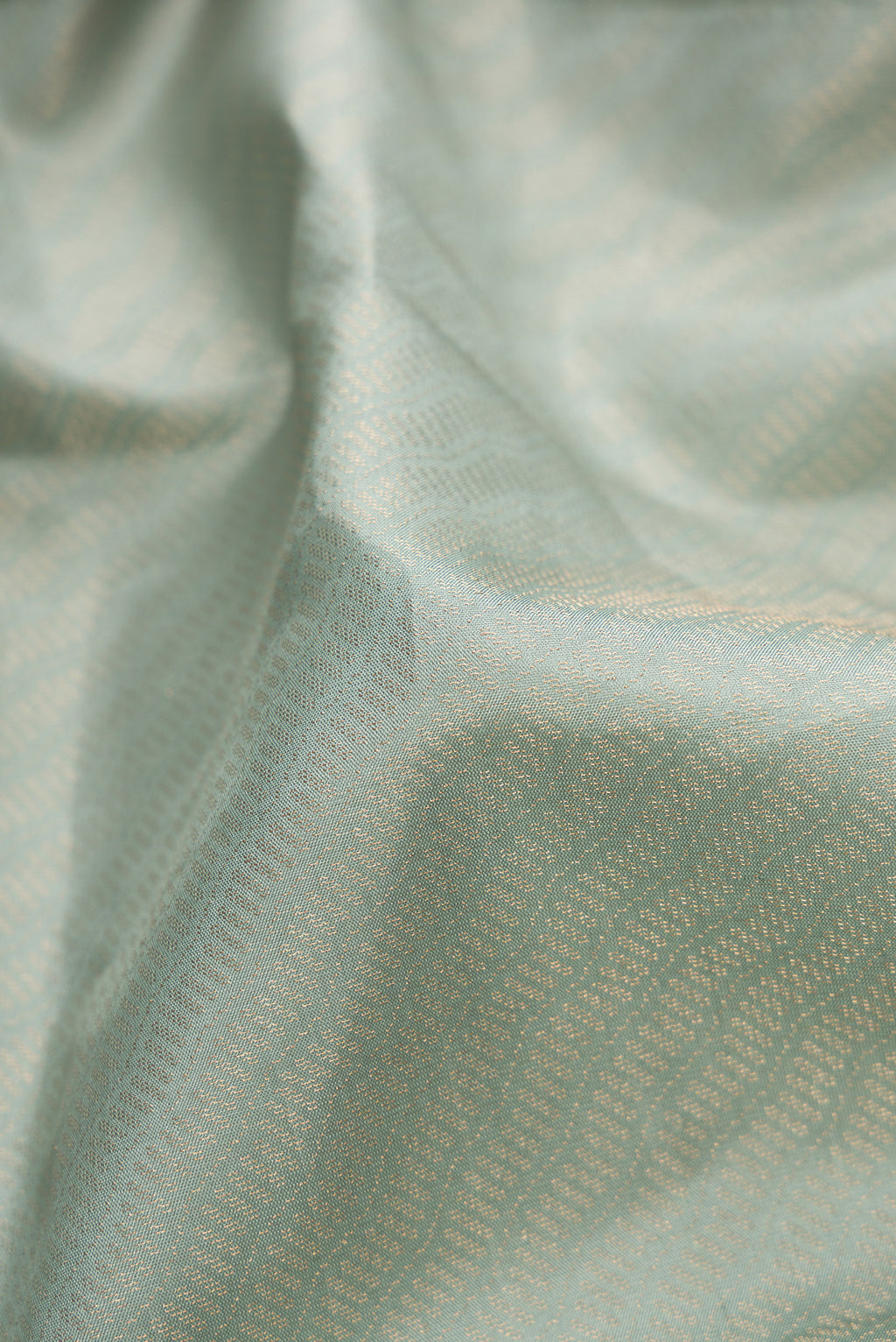Close up of Light Blue Dual Tone Soft Silk Saree with Zari Brocade on the body and Fancy Border.  displaying folds