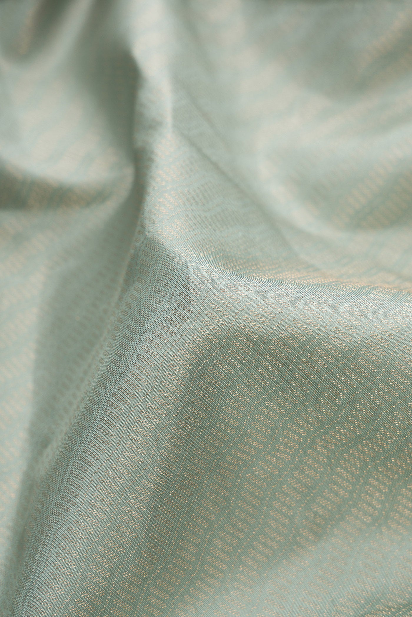 Close up of Light Blue Dual Tone Soft Silk Saree with Zari Brocade on the body and Fancy Border.  displaying folds